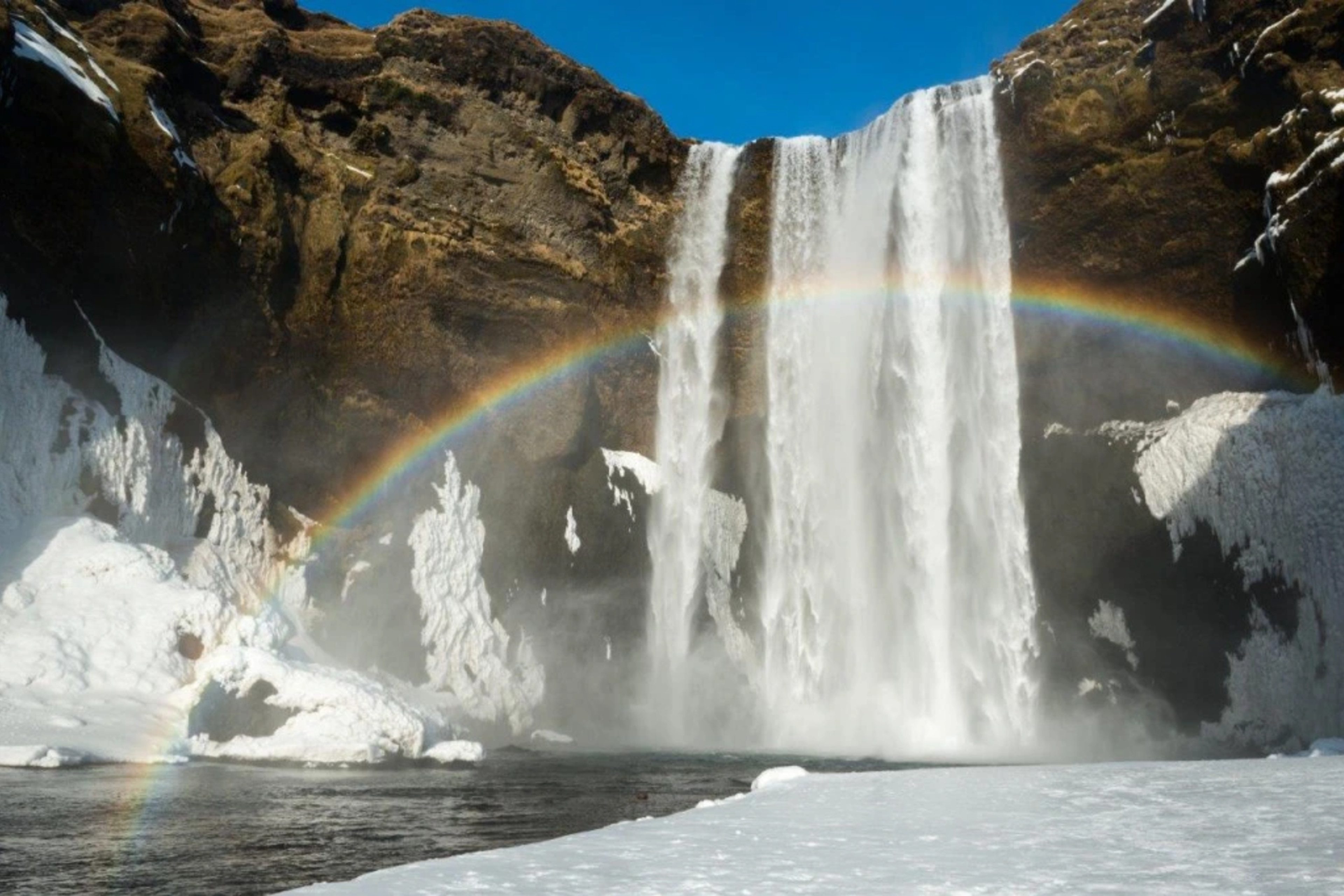 Skogafoss waterfall with rainbow in Iceland