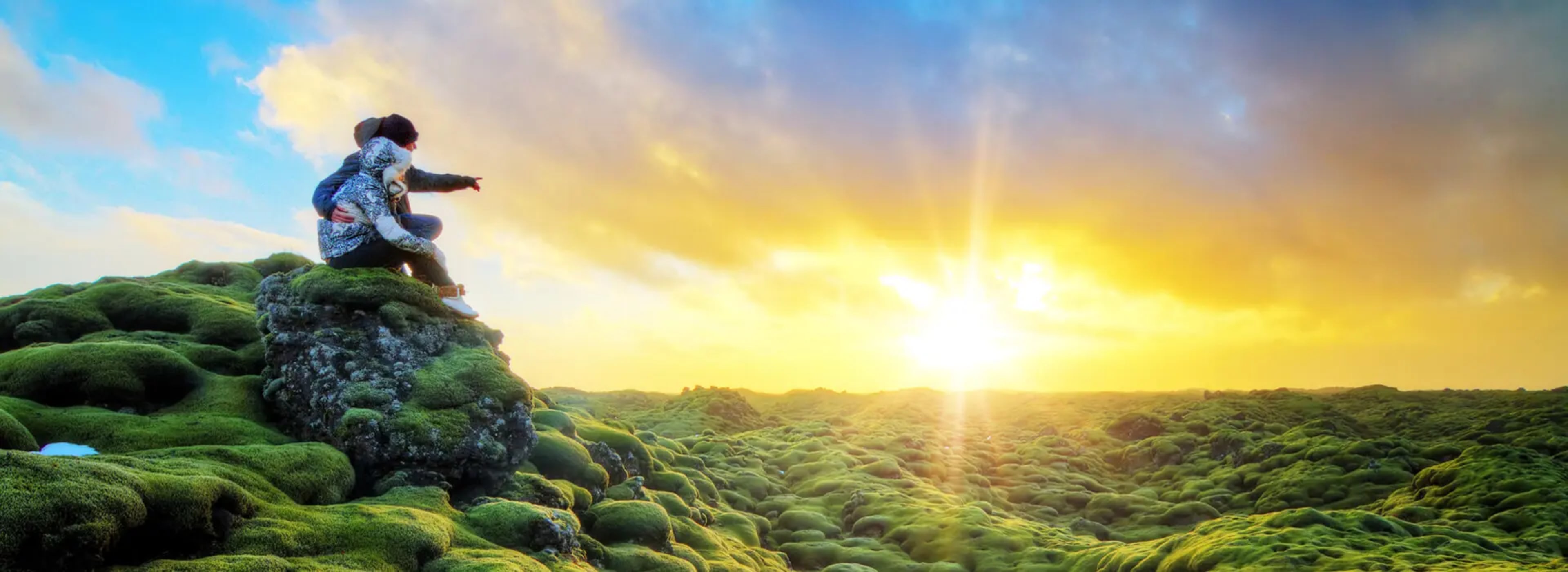 Couple enjoying the view of lava field covered by green moss