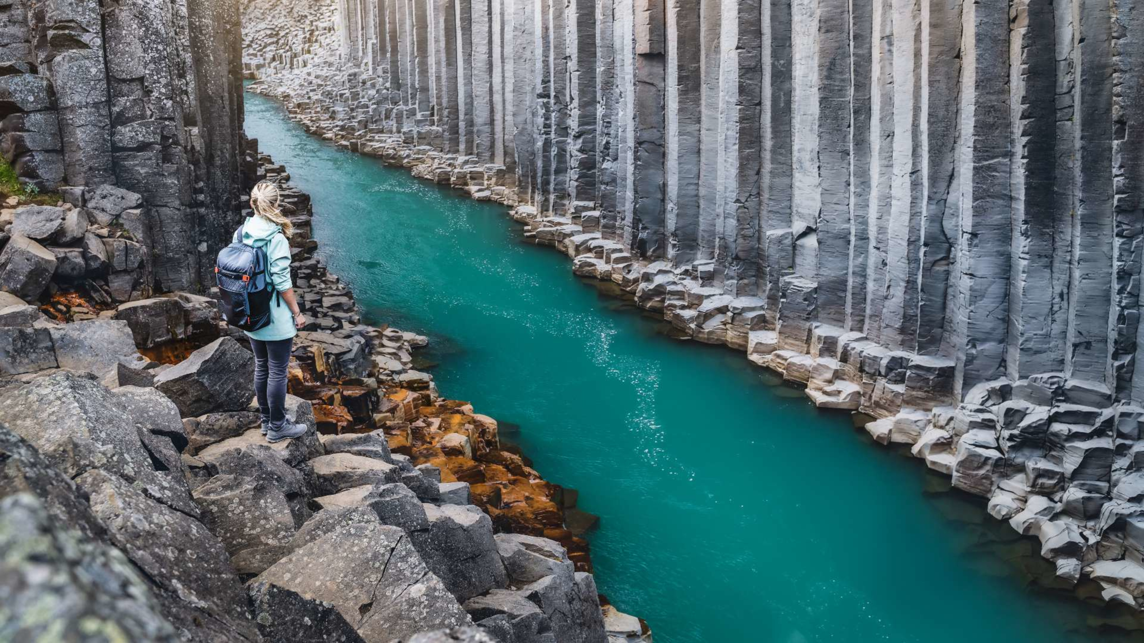 Woman standing at the edge of a canyon in Iceland