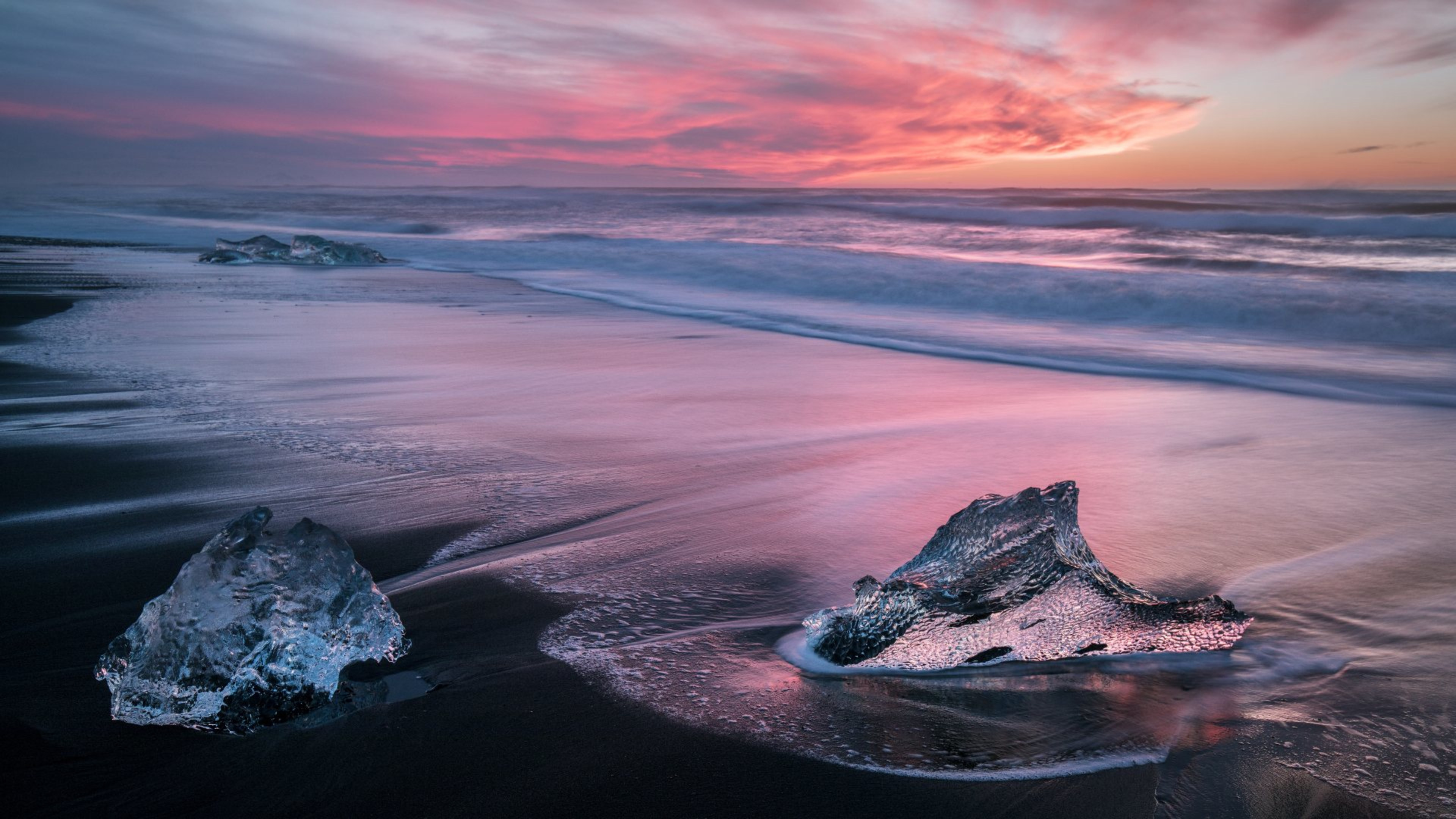 Chunks of ice on Diamond Beach at sunset
