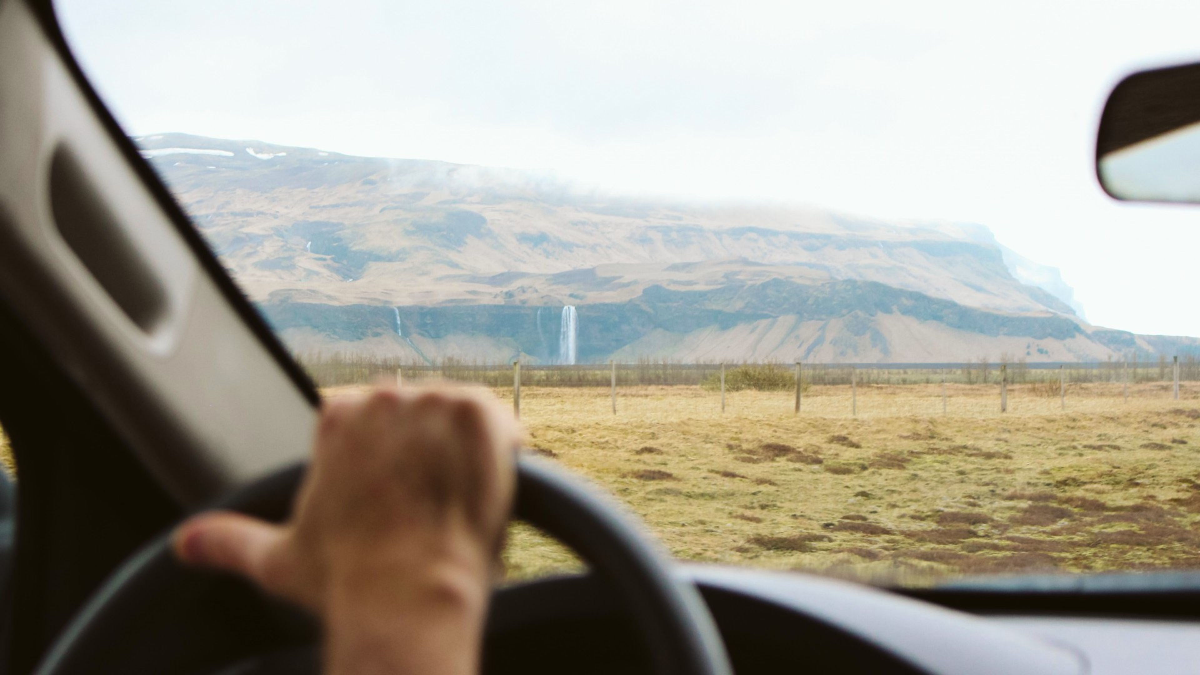 Looking out the windscreen of a car driving near Seljalandsfoss waterfall