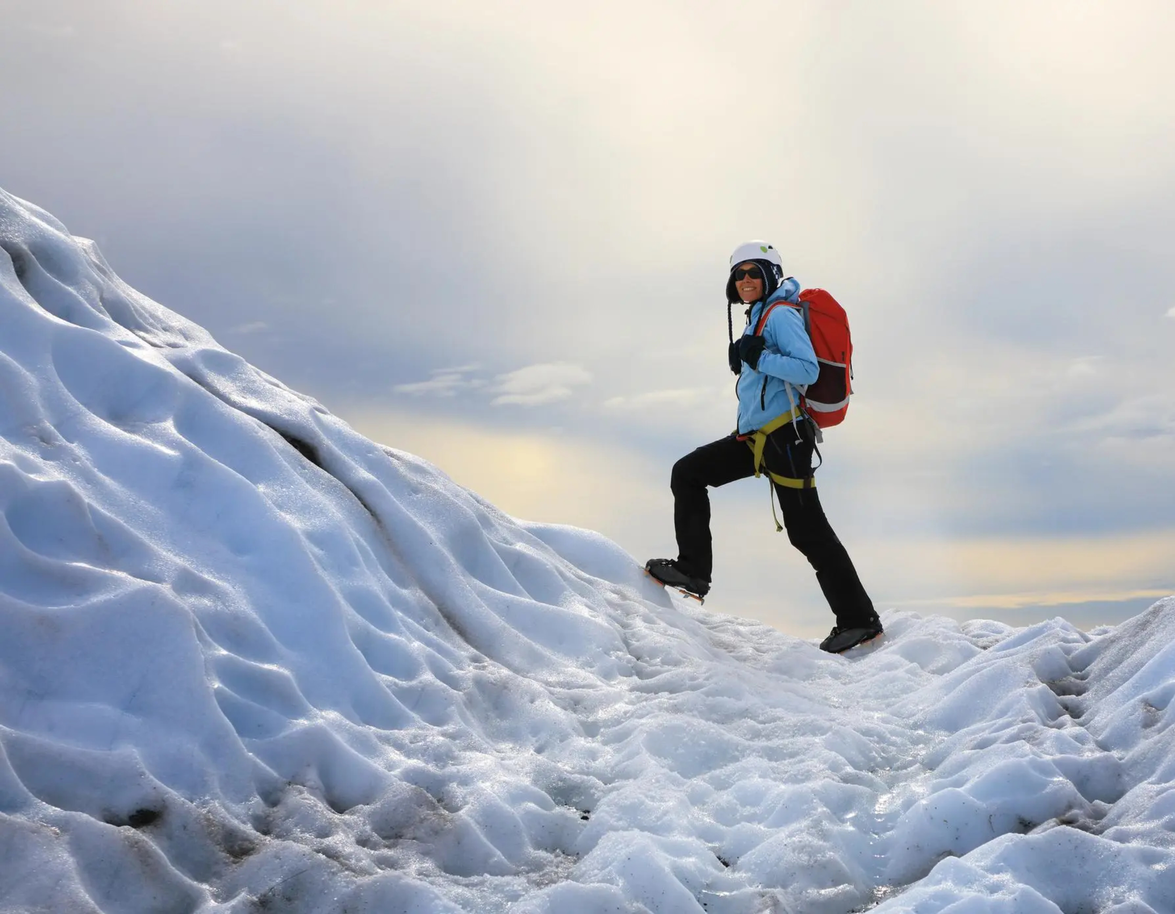Woman climbing a glacier in Iceland