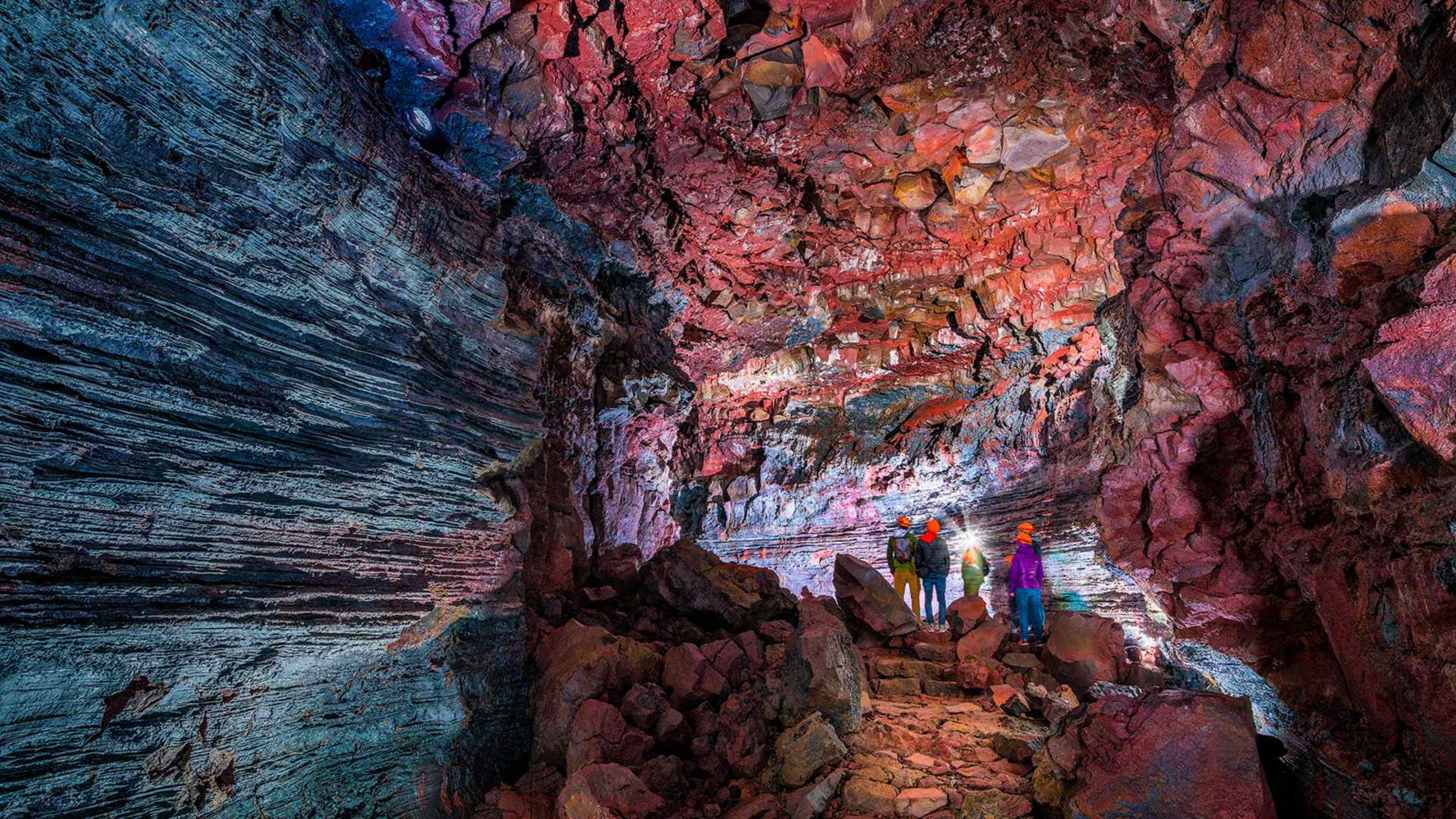 A group of people inside the Raufarhólshellir lava cave