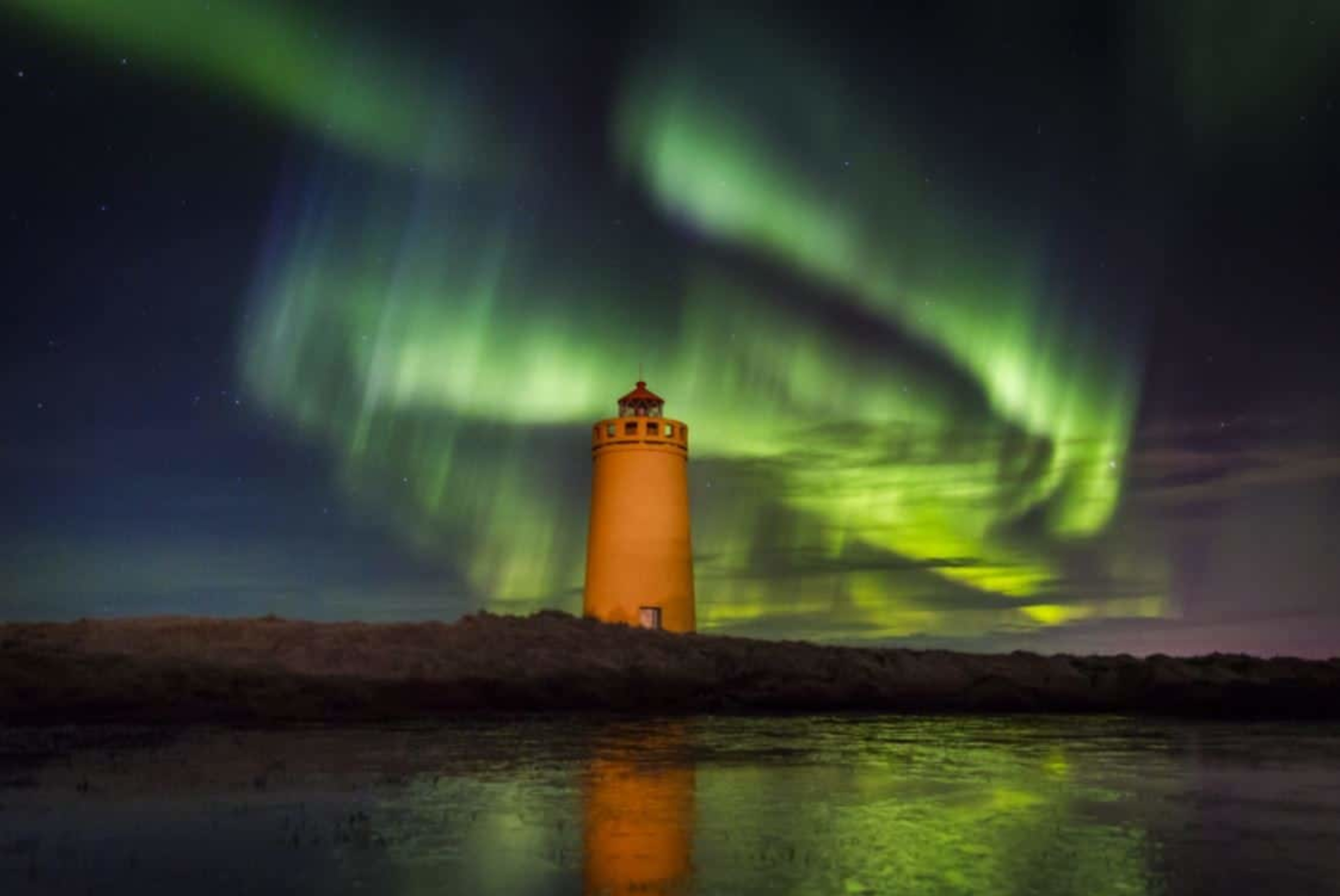 Northern lights above lighthouse