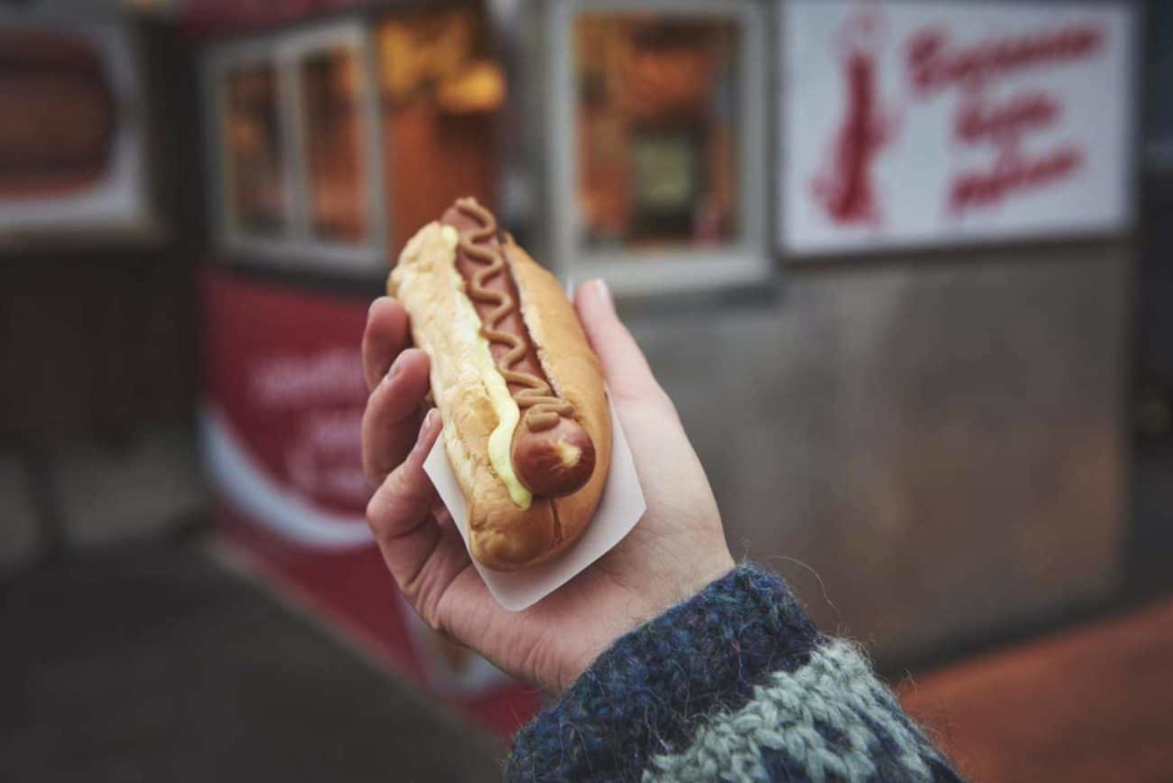 Close up of a hand holding a hot dog