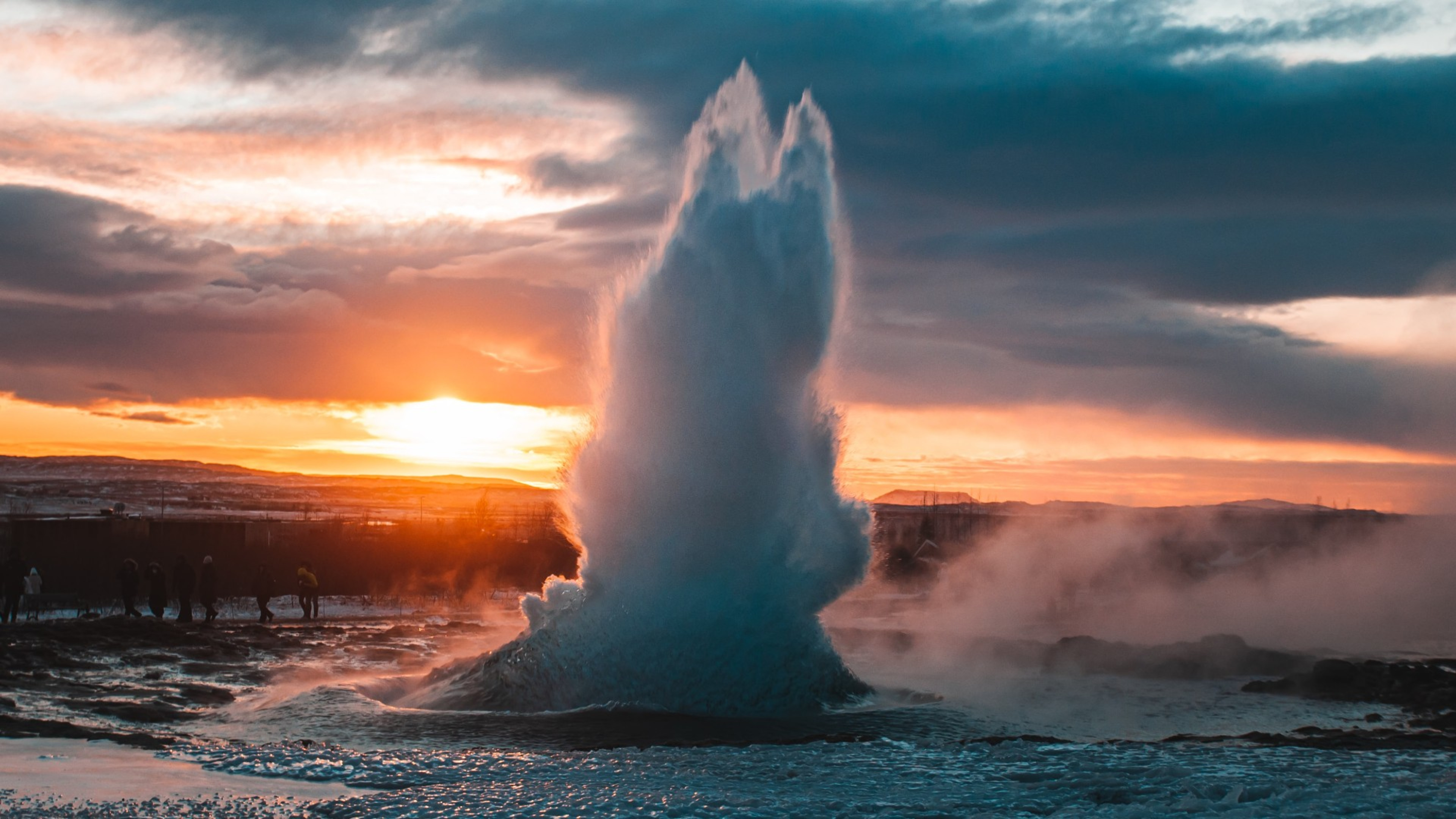 The Strokkur geyser erupting against the winter sun