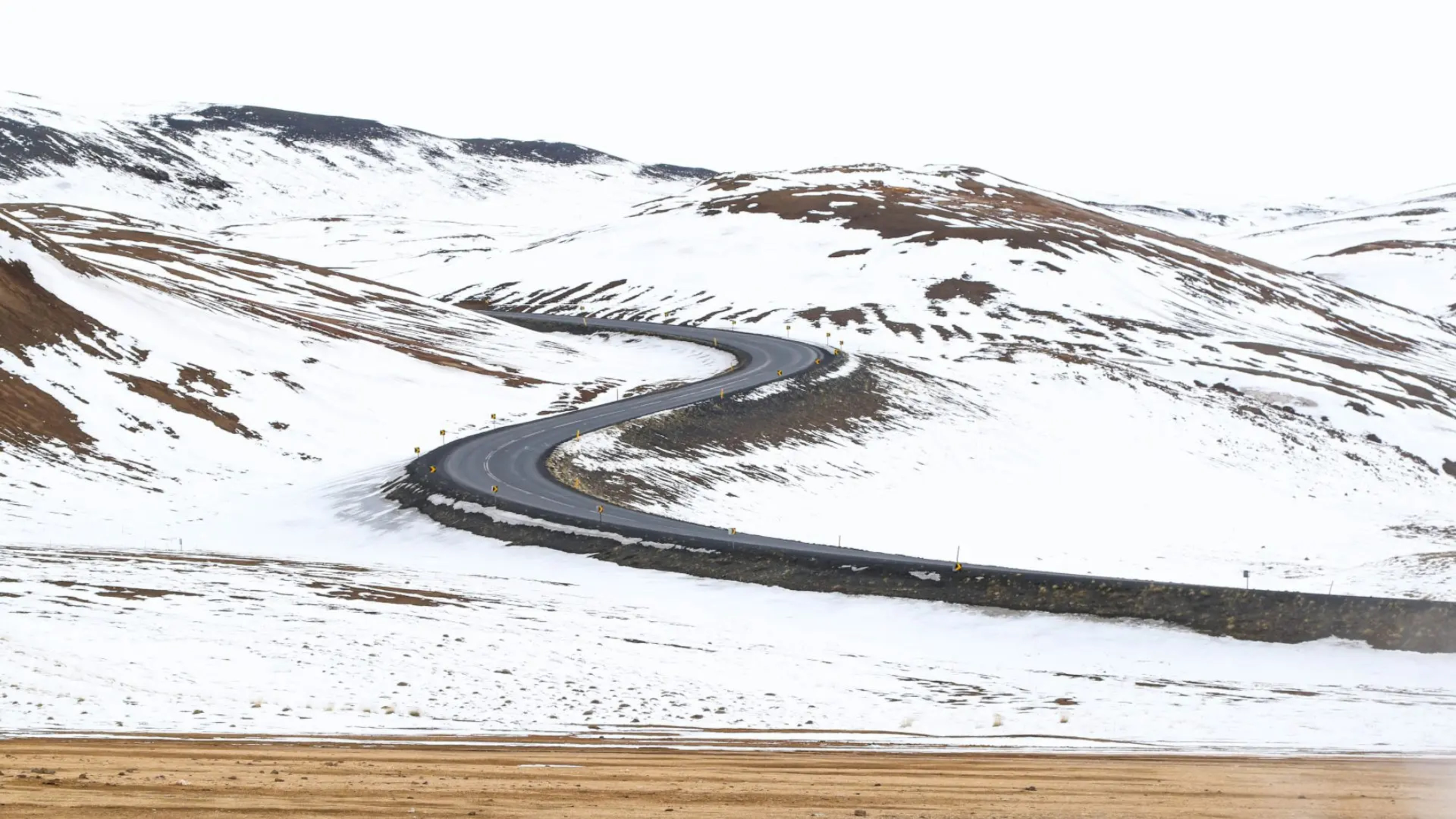 windy road up a snowy hill