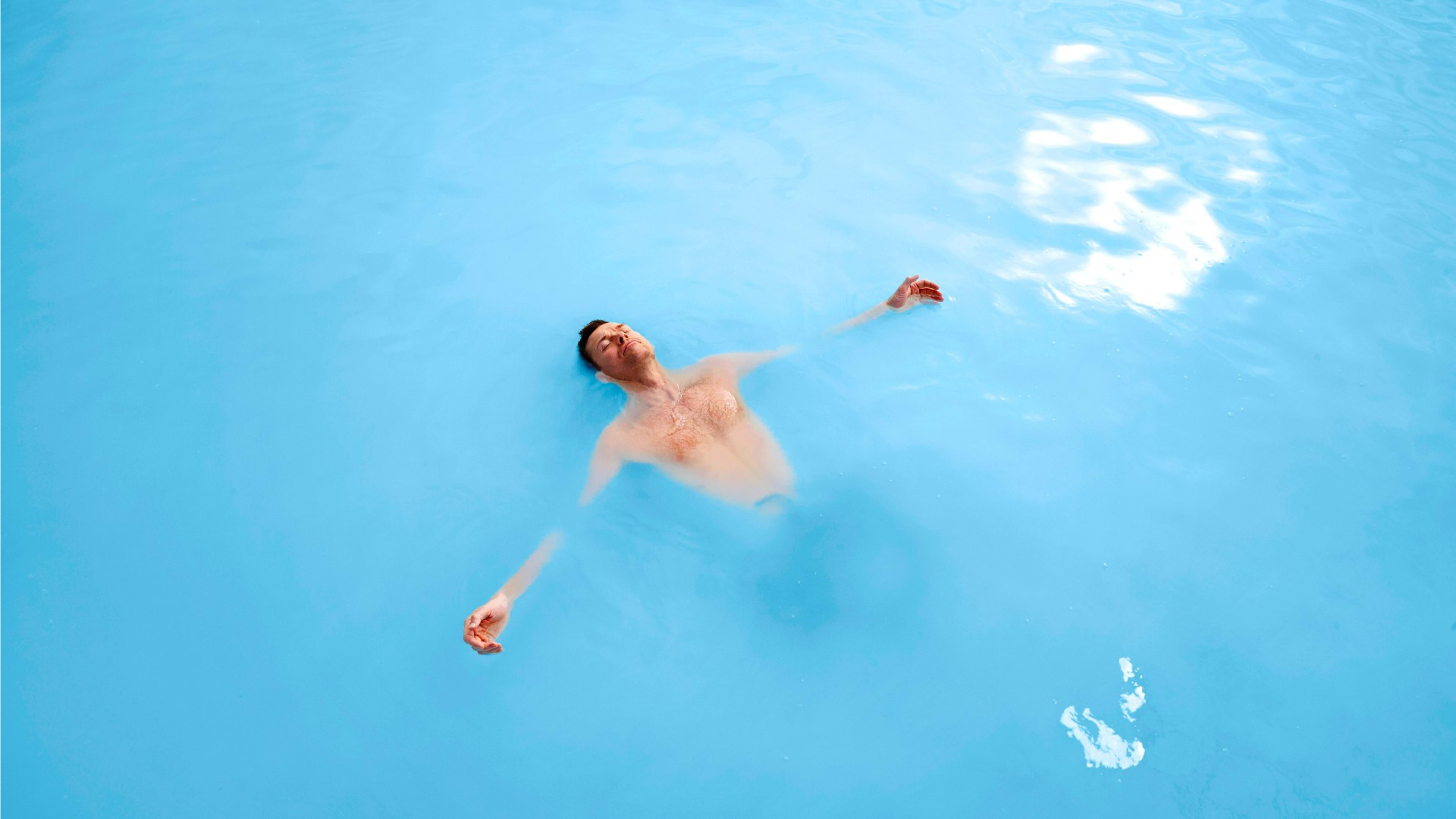 A man floating in the Blue Lagoon