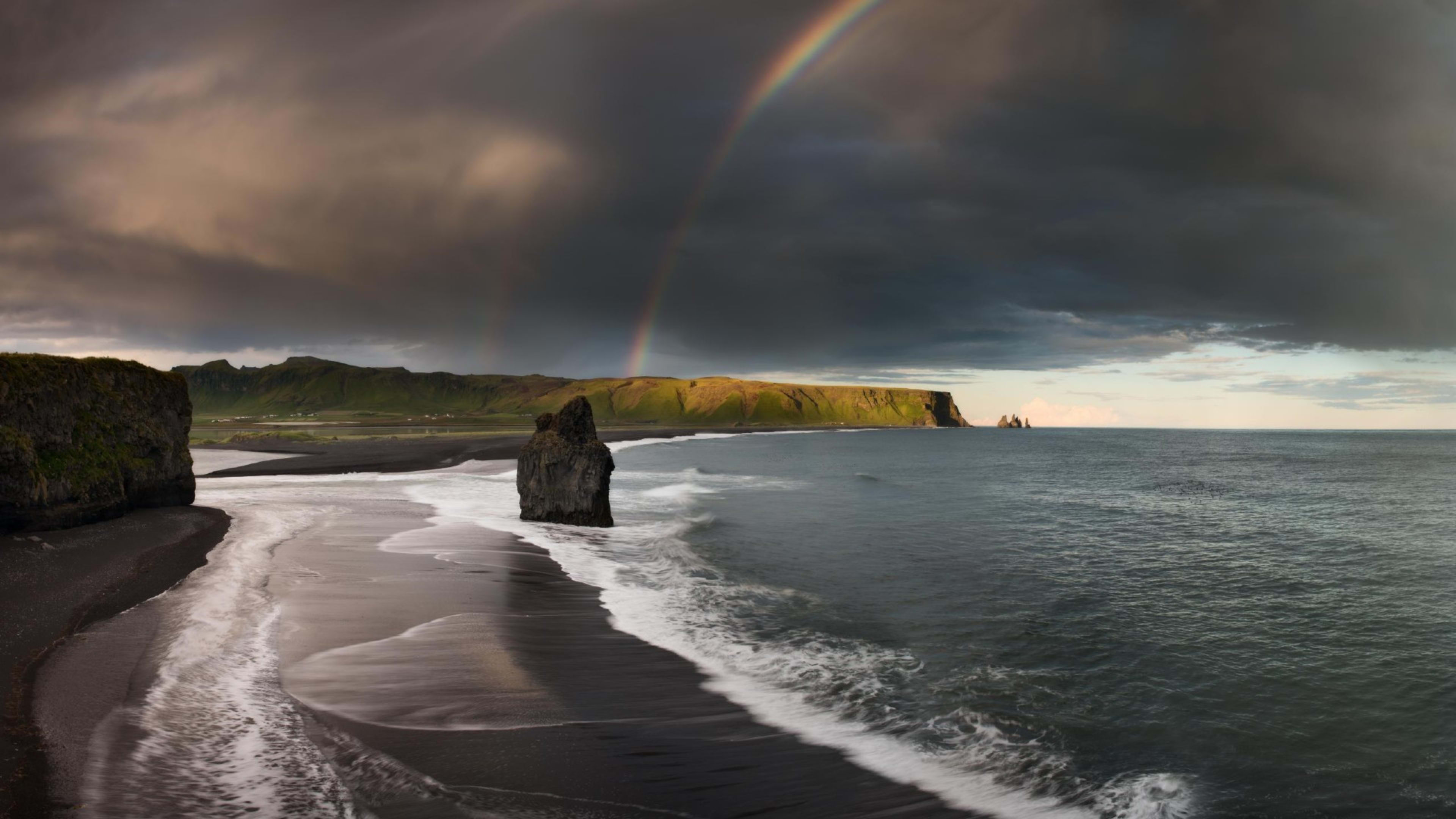 A rainbow over Reynisfjara black sand beach