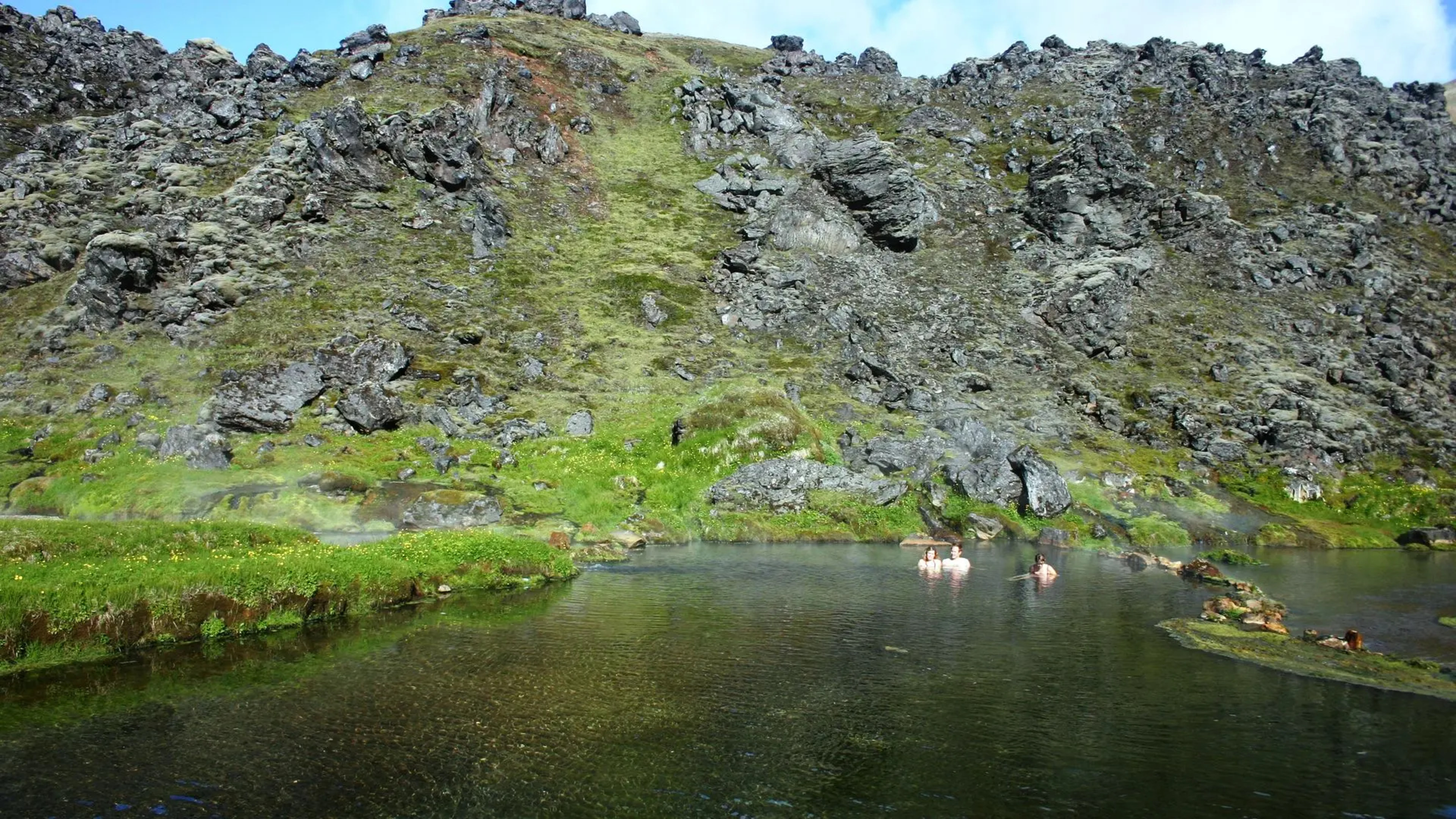 People bathing in the natural hot springs at Landmannalaugar