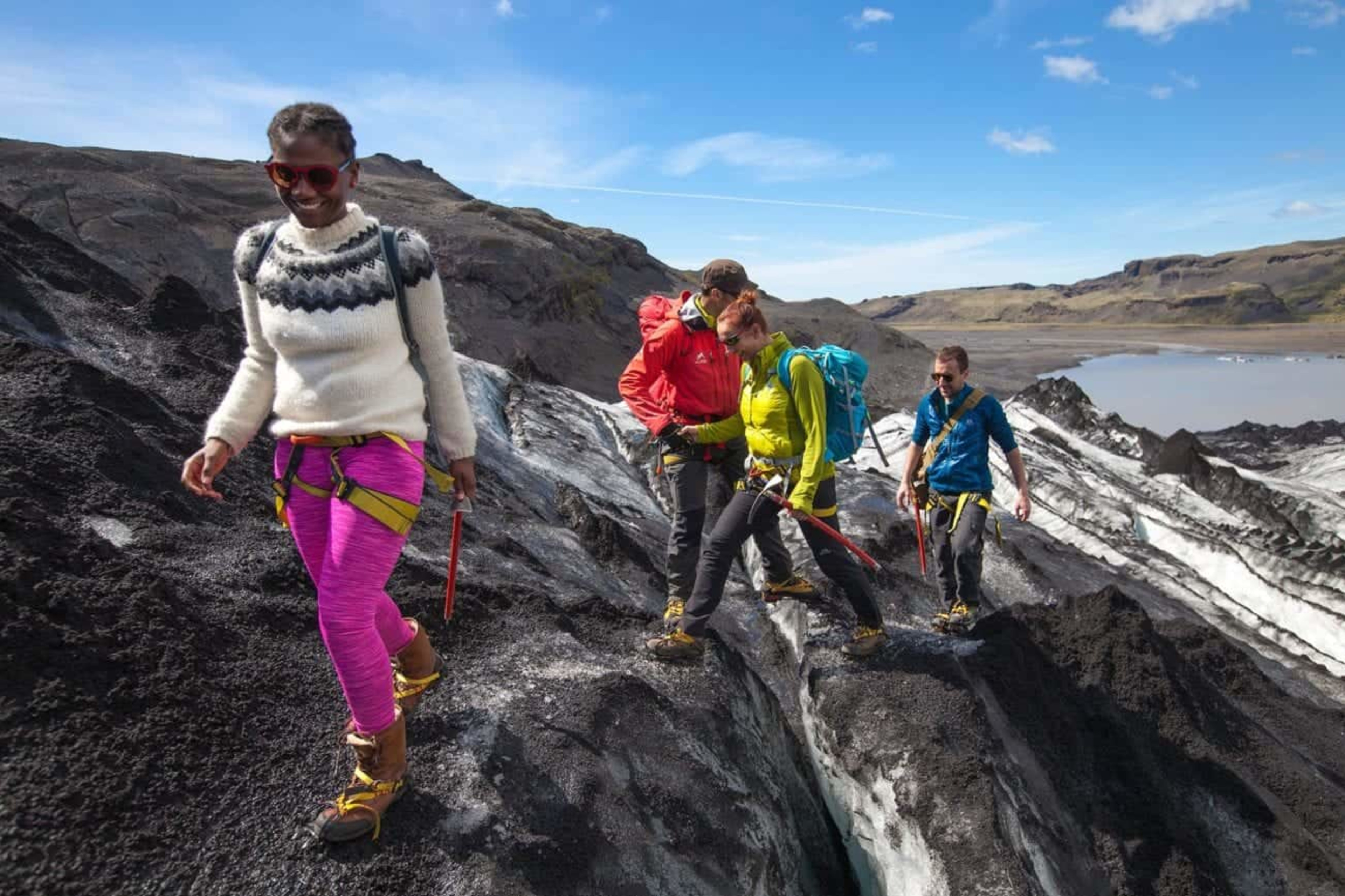 A group of people walking on a glacier