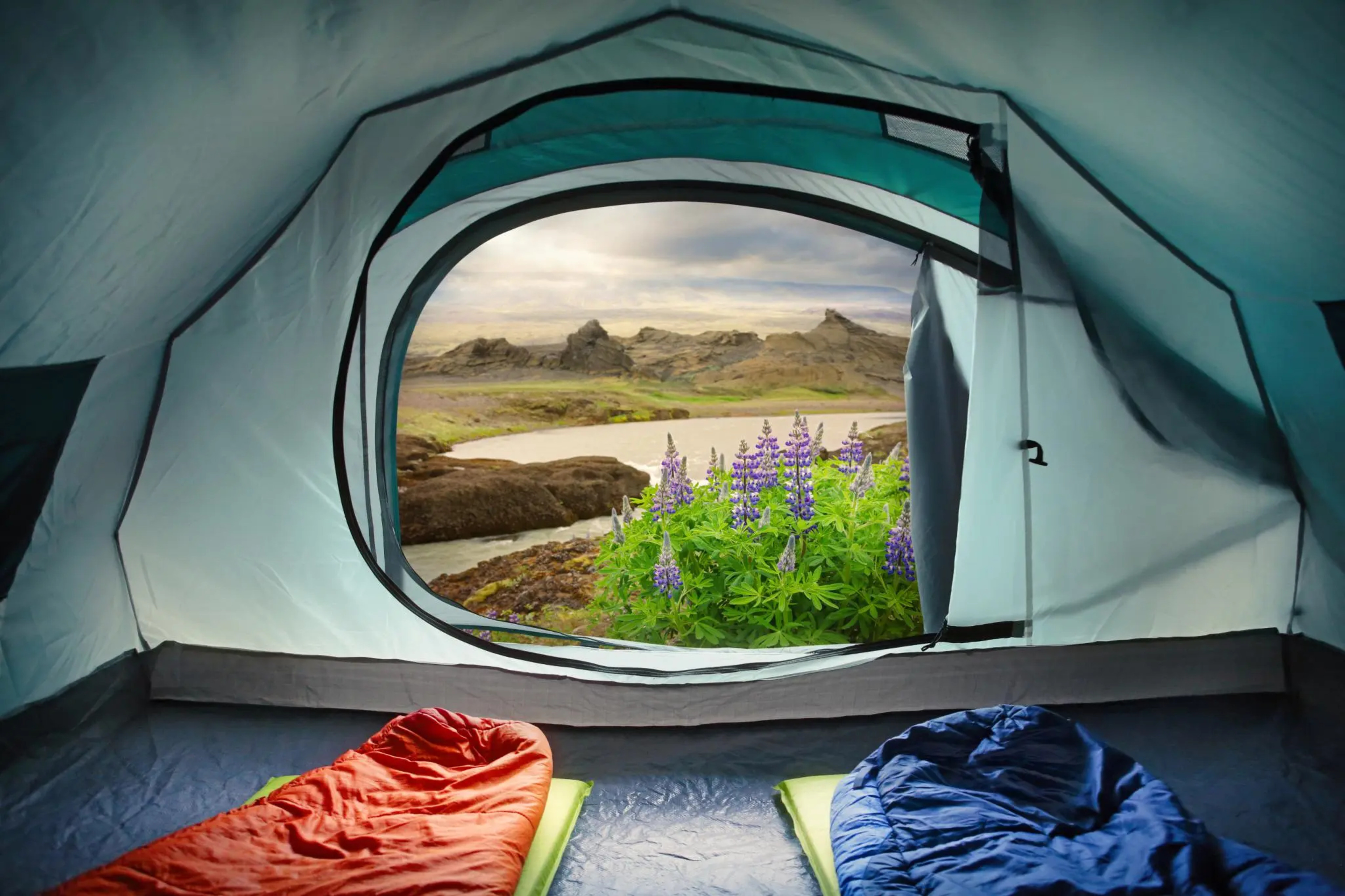 Camping in Iceland river and mountains view from the open tent