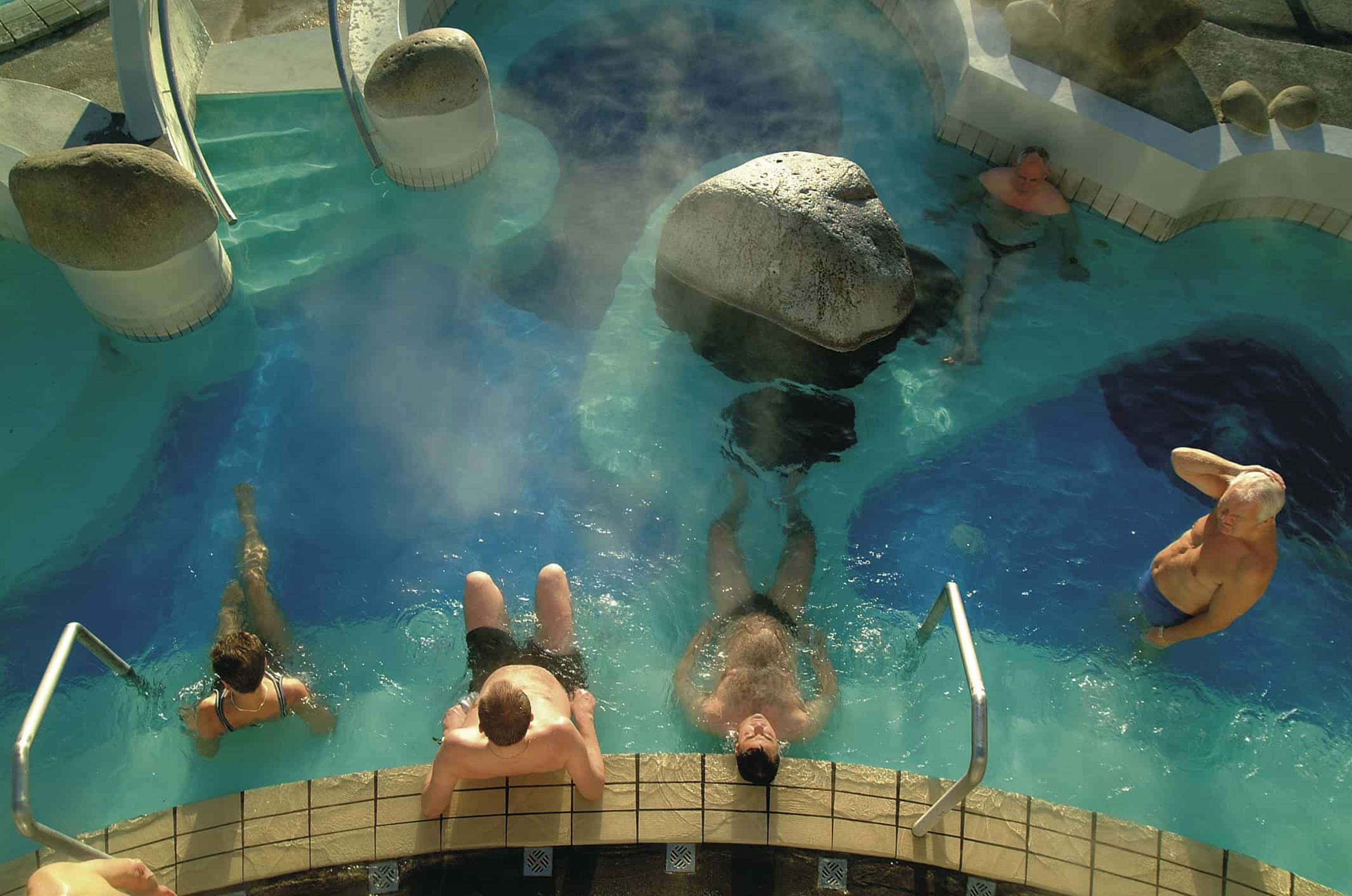 Top view of people relaxing in the pool