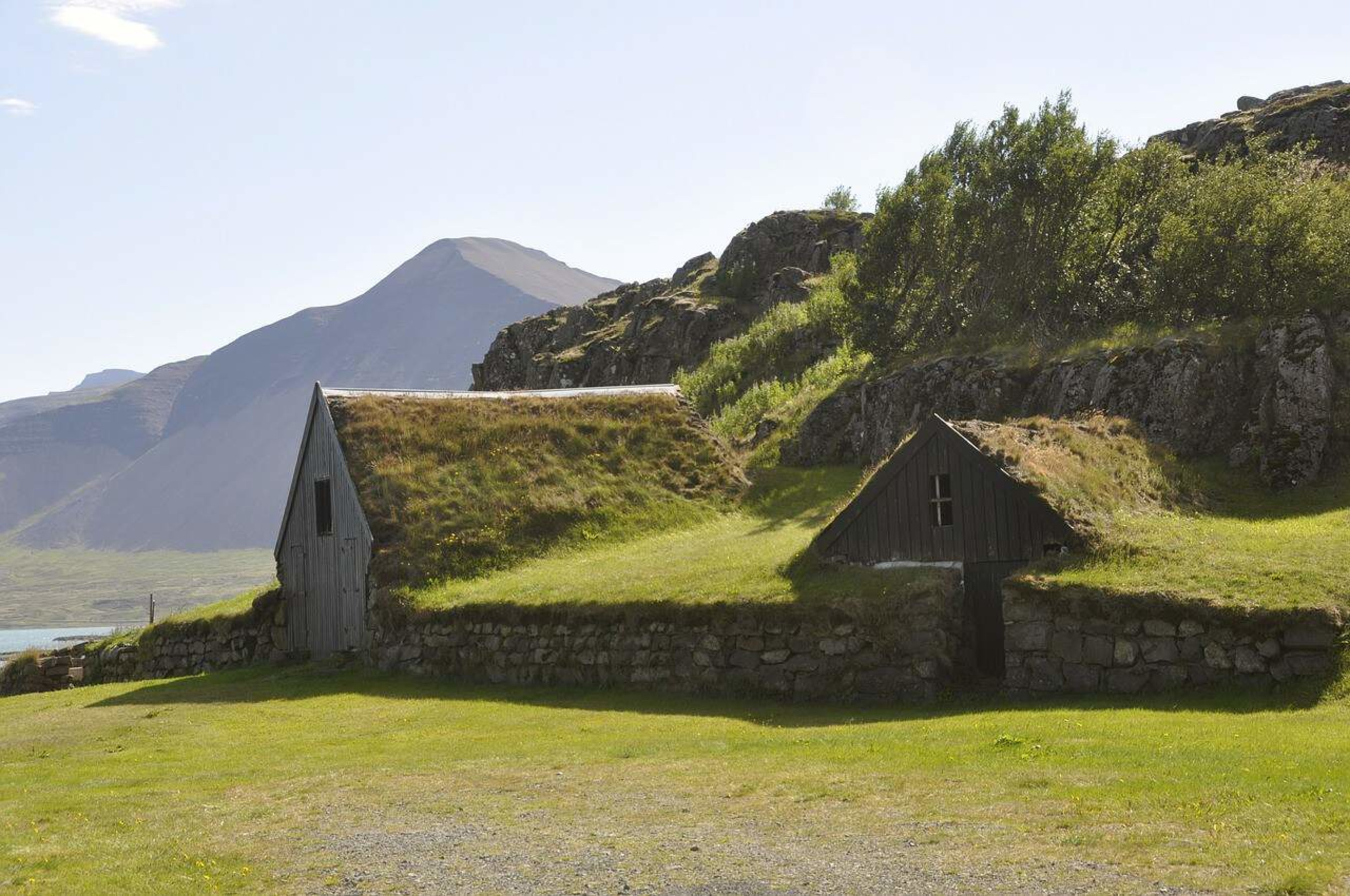 2 nearby turf houses set into a green hill