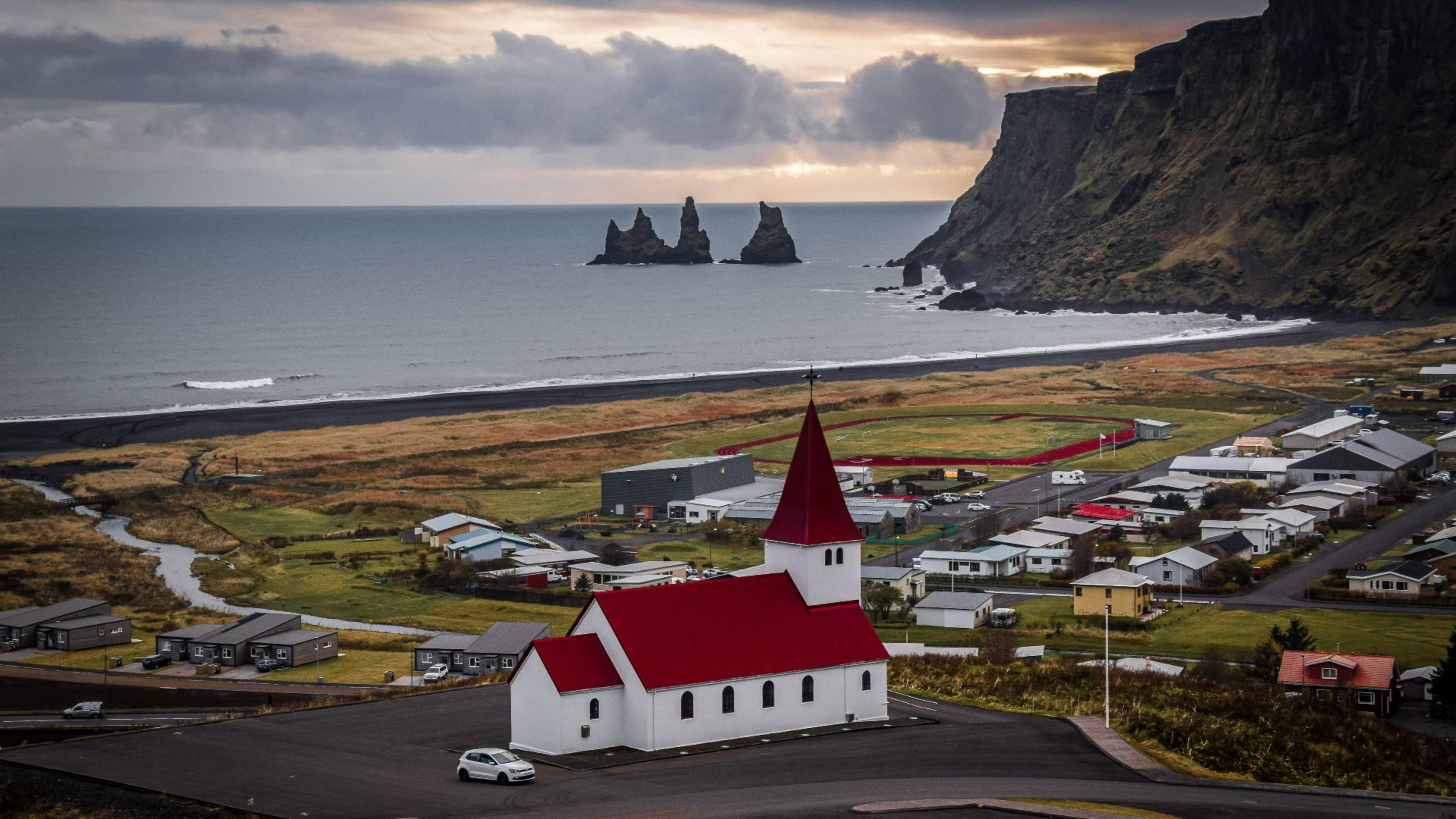 Vik Church with Reynisdrangar sea stacks in the distance