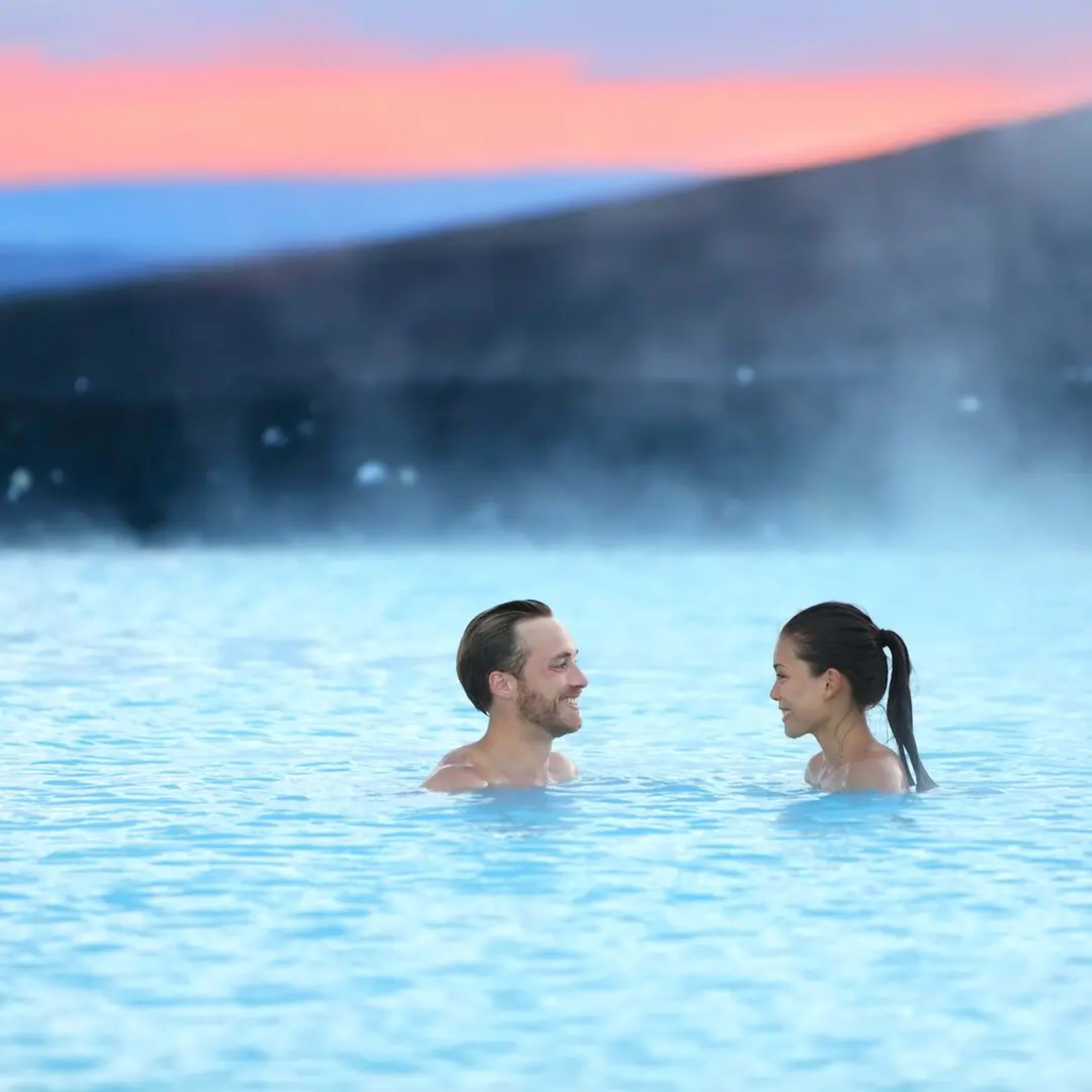 Couple relaxing in an Icelandic geothermal-pool