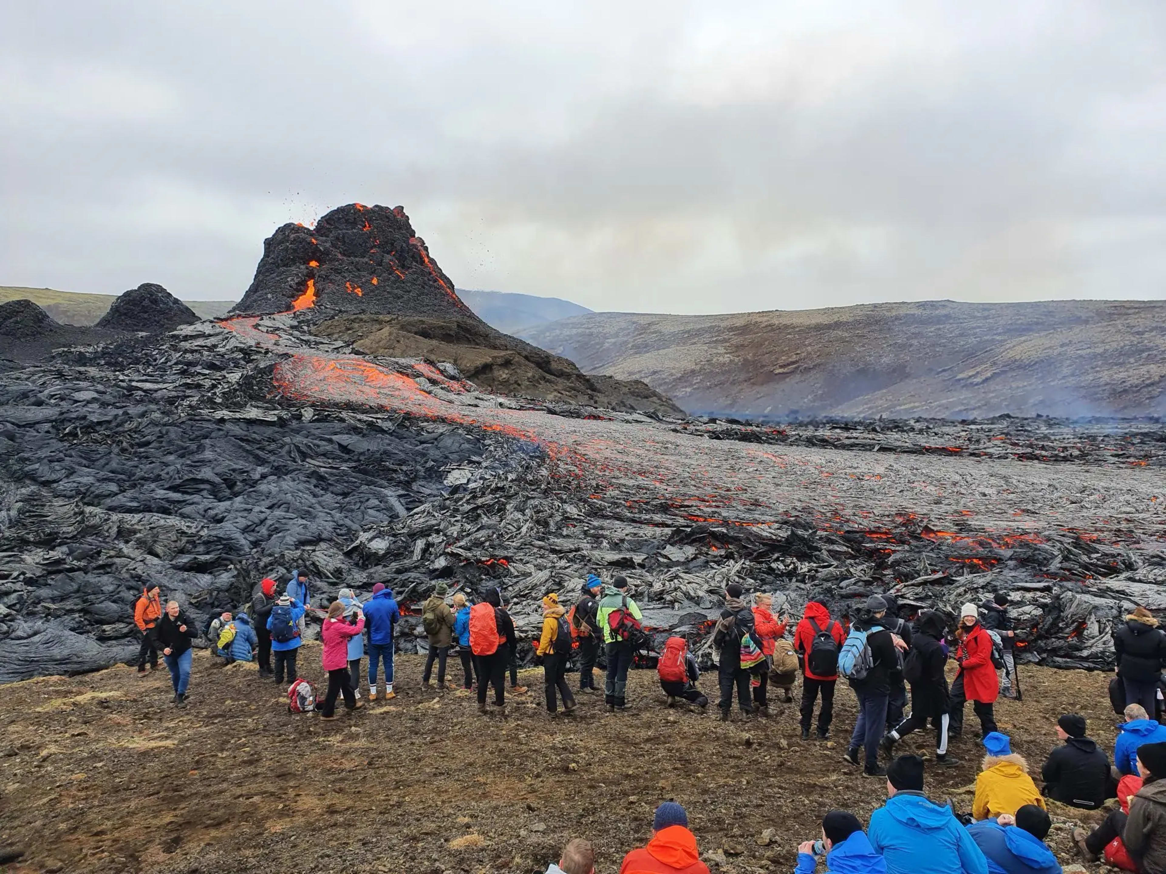 People watching lava flows at Fagradalsfjall volcano, Iceland