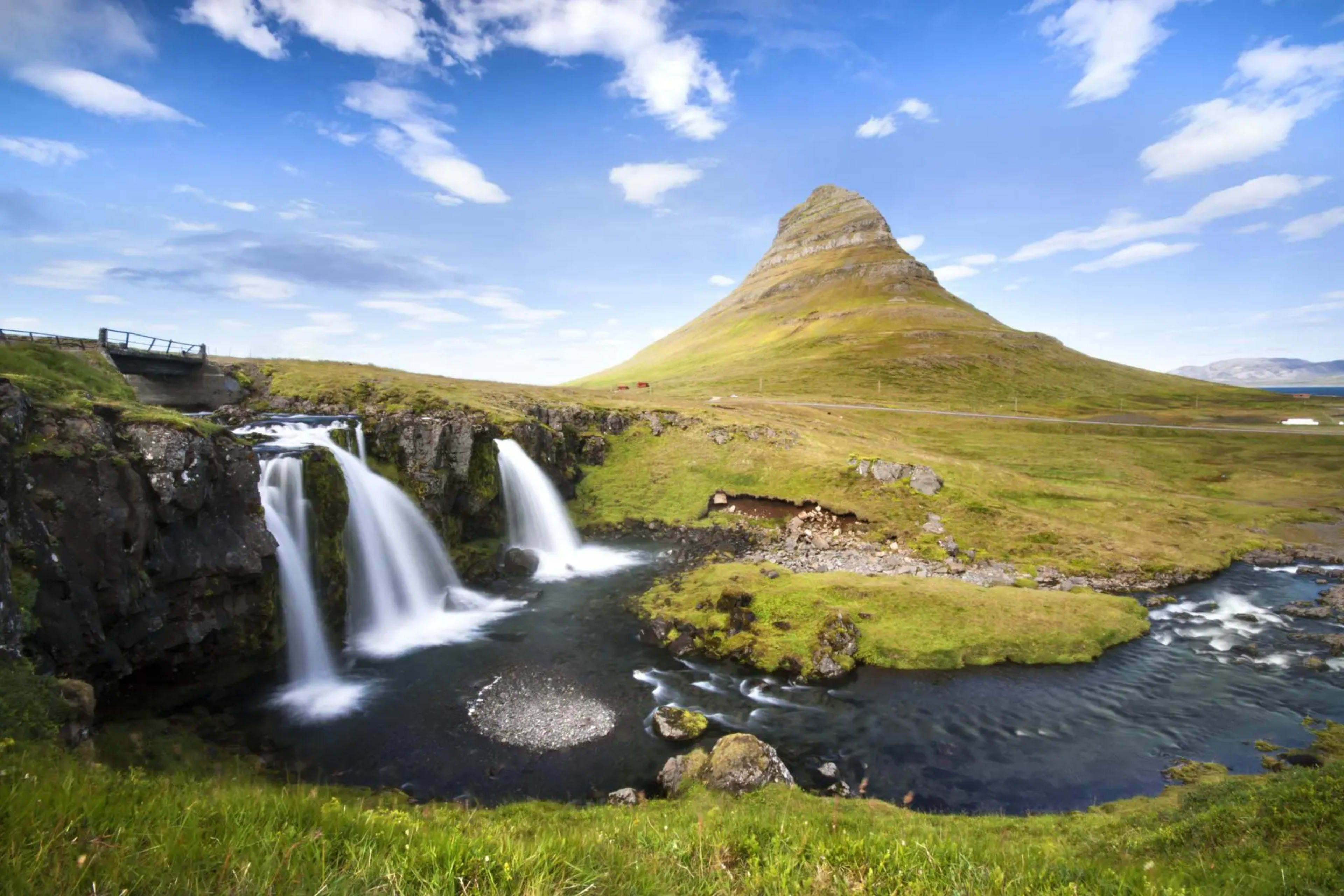 Kirkjufell mountain and waterfall with blue skies above