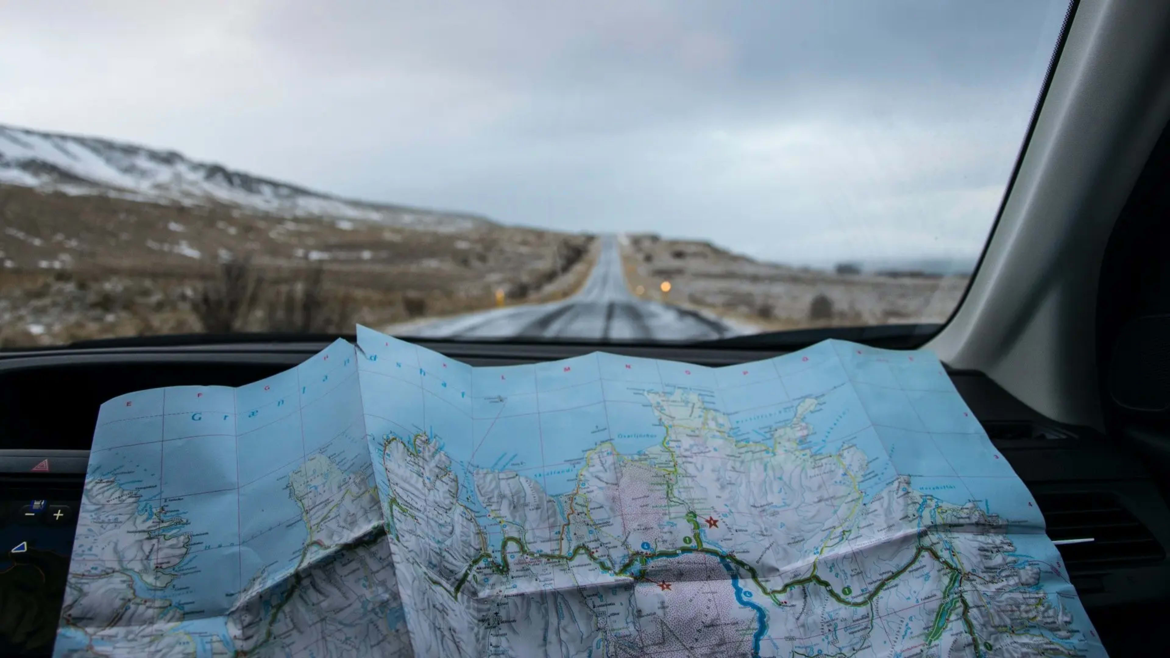 A map of Iceland in a car, looking out onto the road