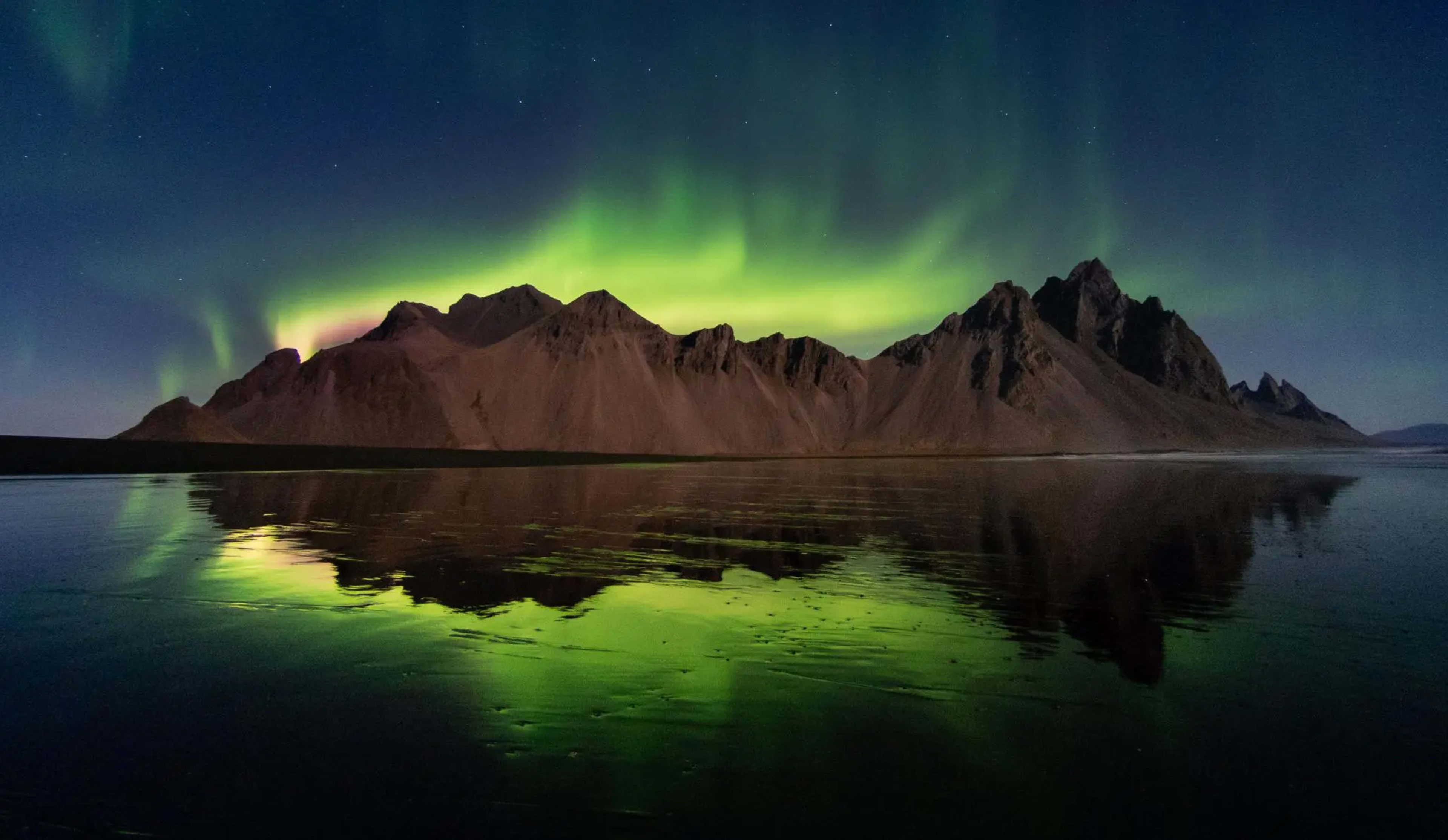 Northern Lights glowing behind the Vestrahorn mountains