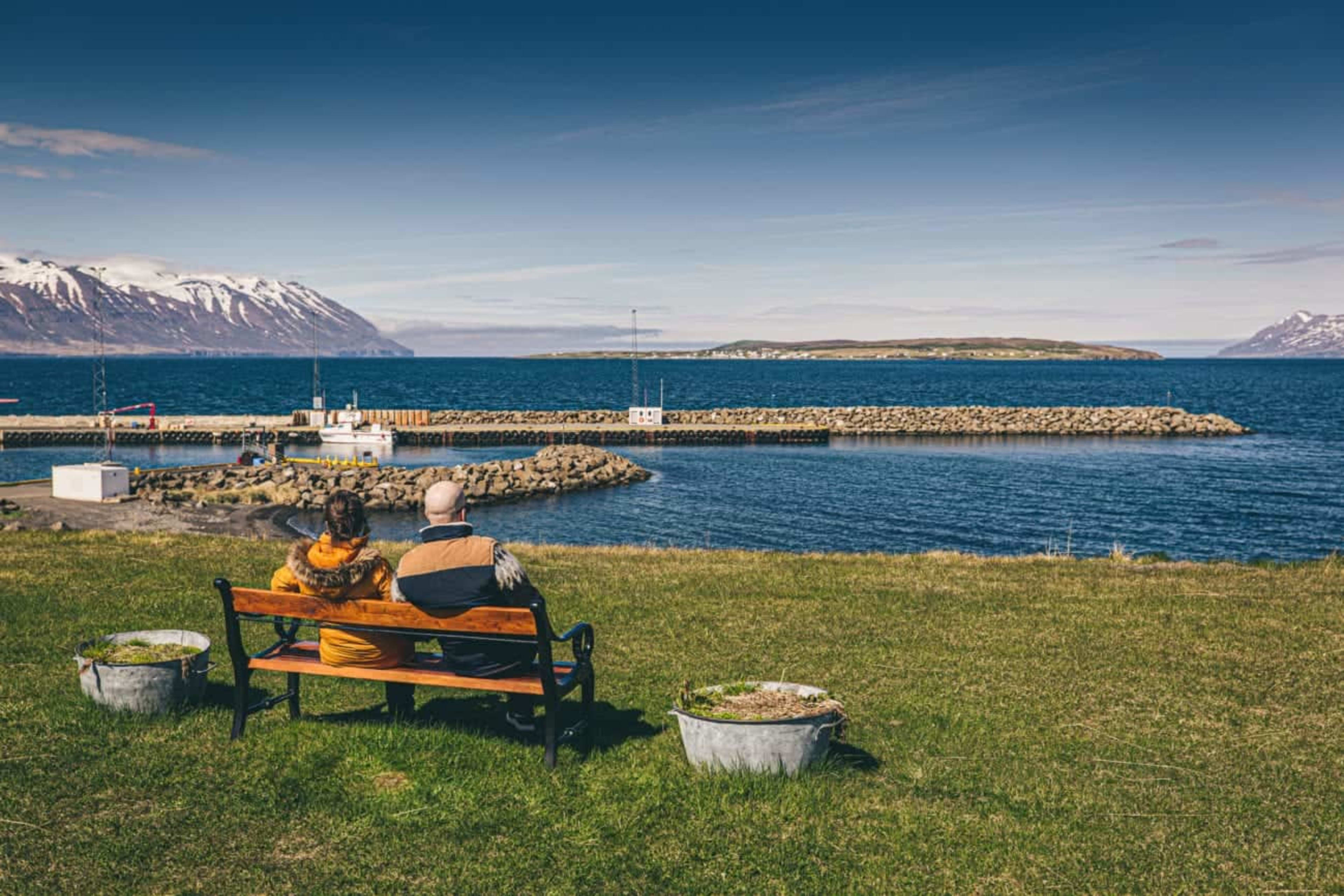 Couple sitting on bench and enjoying the view over Skagafjörður