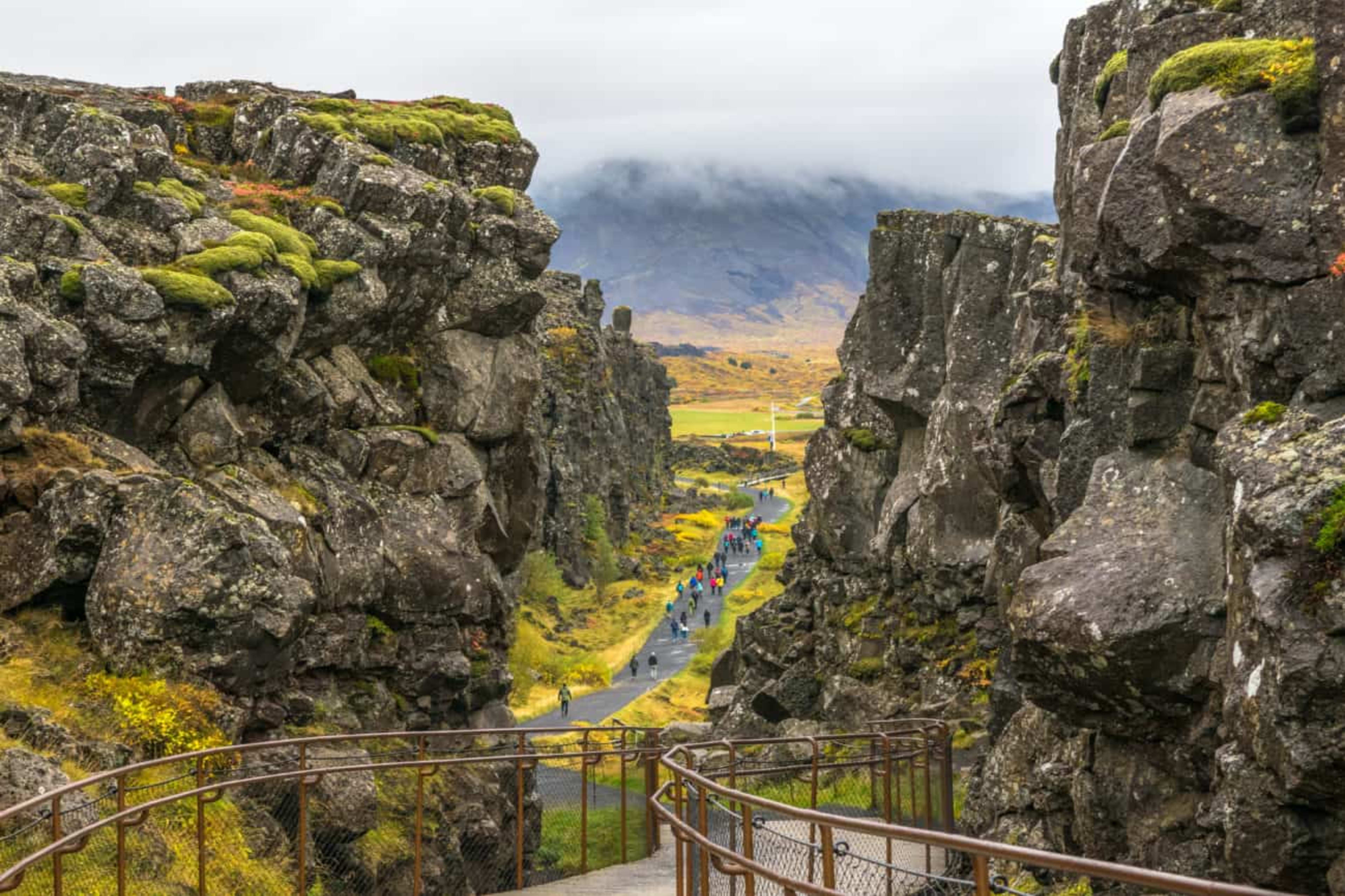 Thingvellir National Park - view of people walking in the seam between the Eurasian and North American tectonic plates