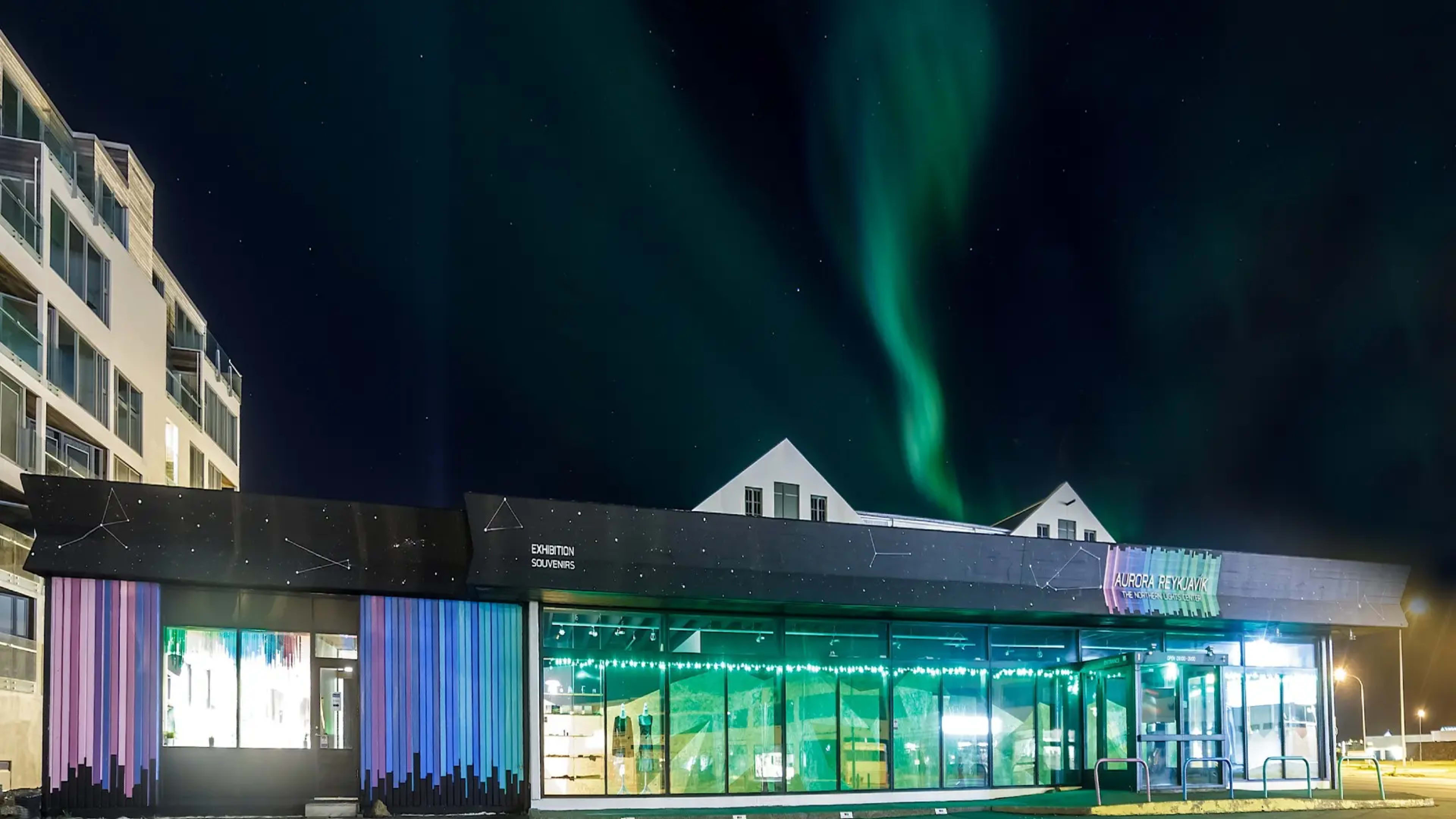 The Northern Lights visible above the Aurora Reykjavík museum