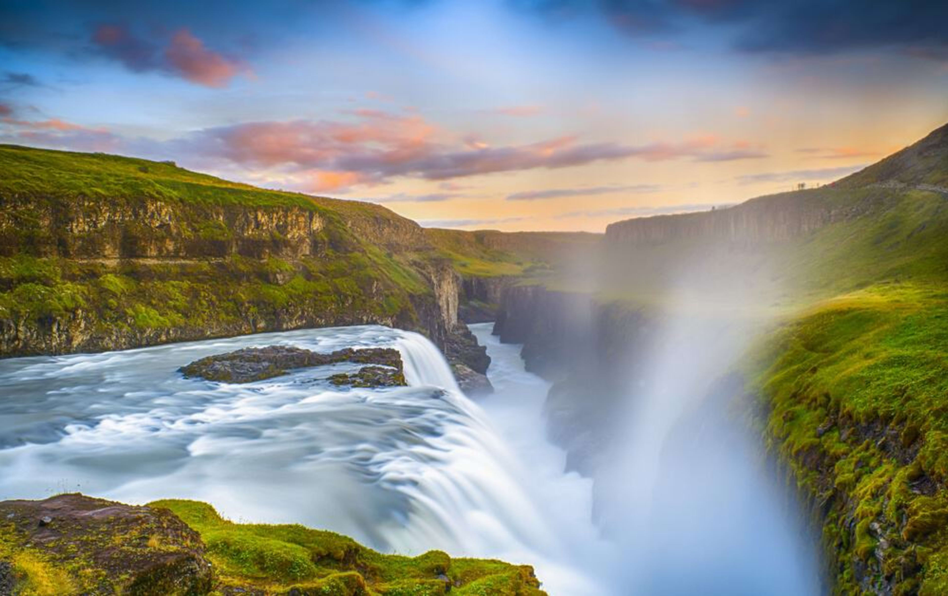 Gullfoss waterfall in Iceland with a sunset in the background