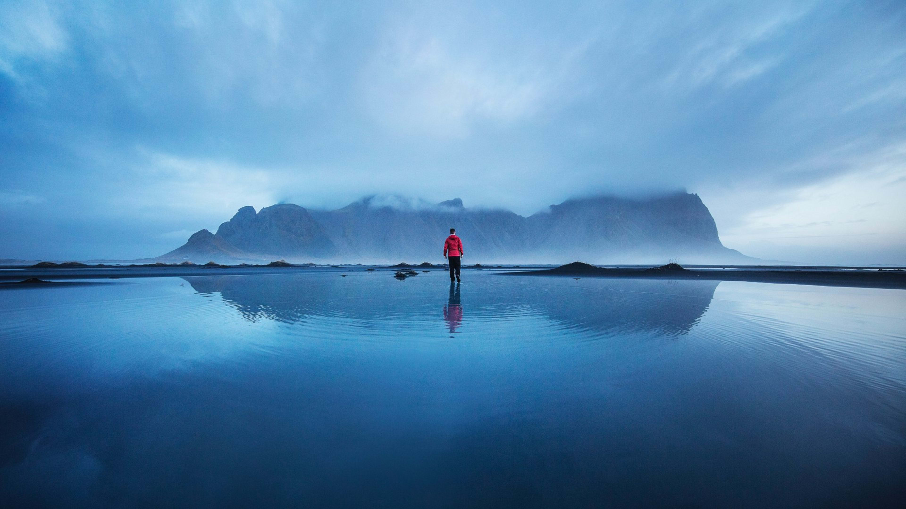 A man standing on the beach at Stokksnes, East Iceland