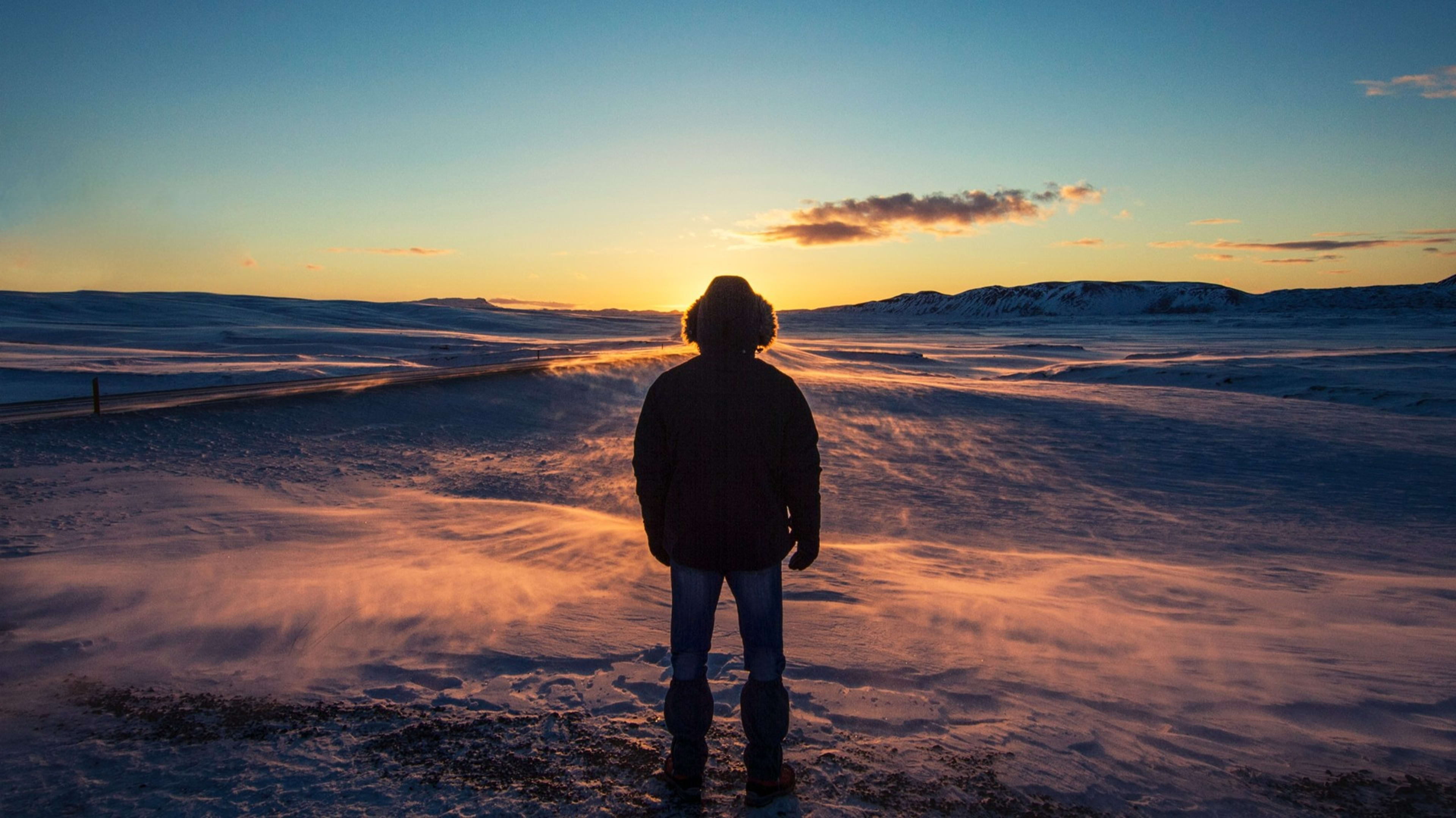 Man in the snow with a sunrise view in Iceland