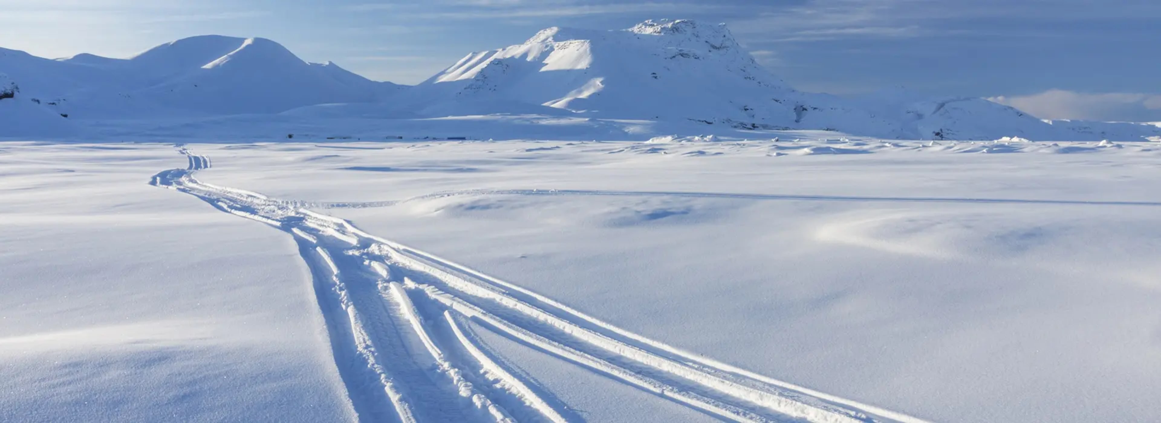 Snowmobile tracks in the mountain snow