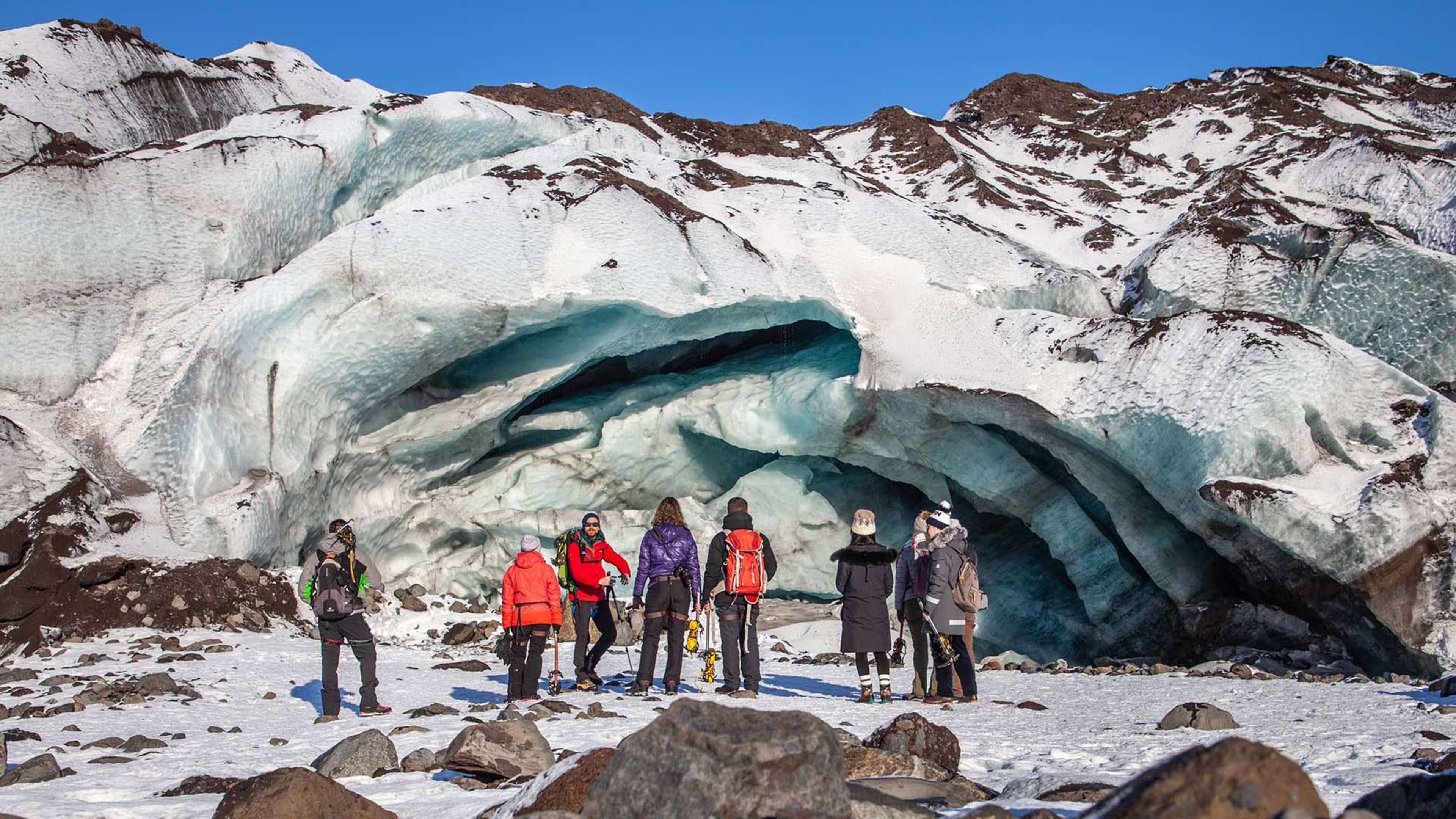 A group of people standing in front of a glacier © Icelandic Mountain Guides