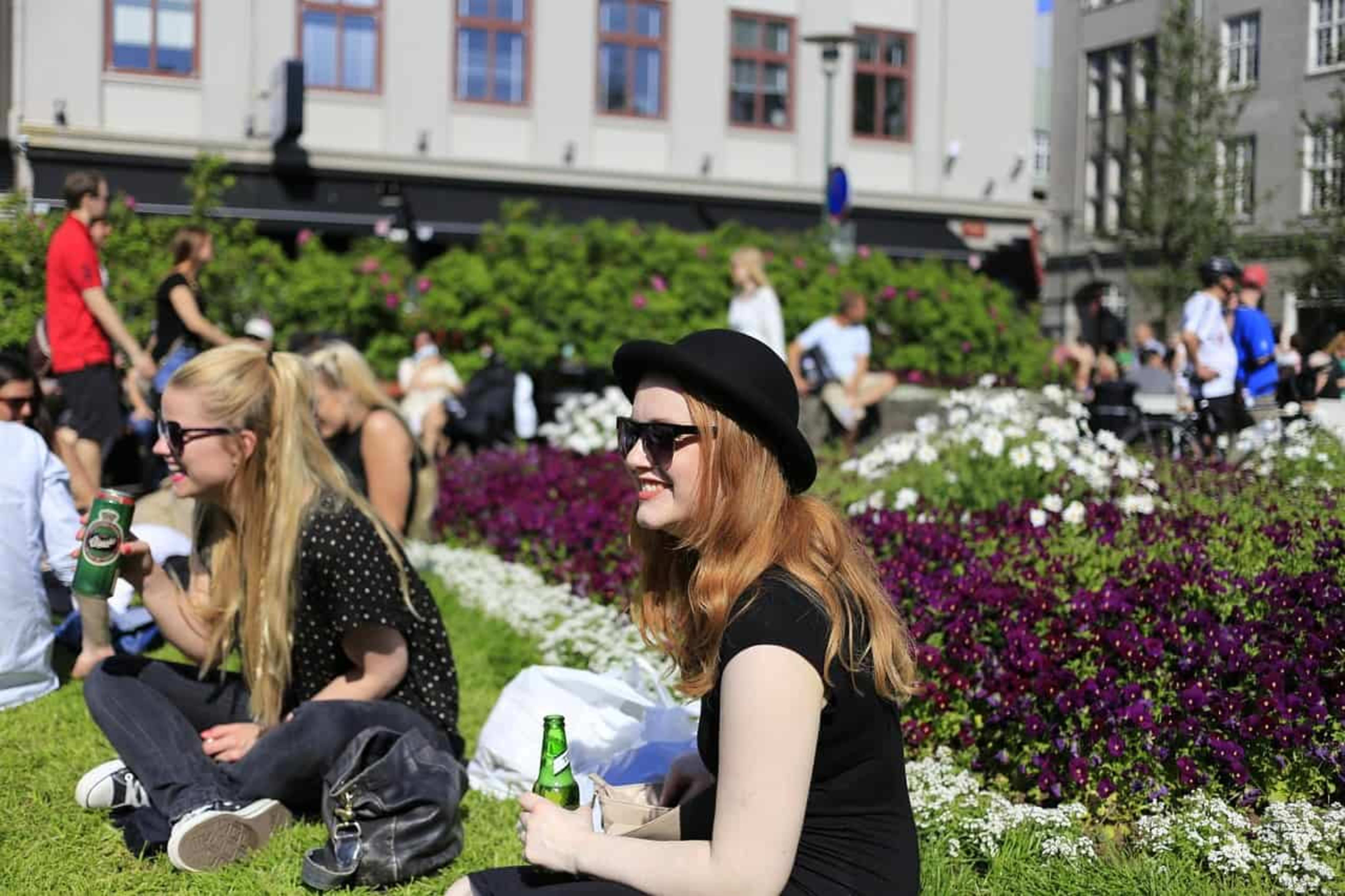 People sitting in the park and enjoying the sunshine in Reykjavik