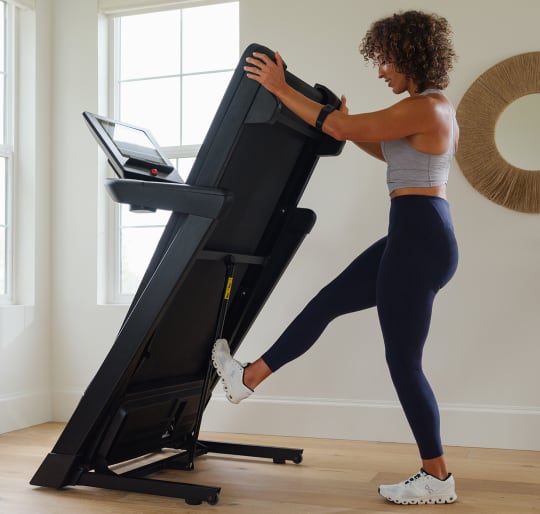 woman using the easy lift feature of the EXP 14 for storage