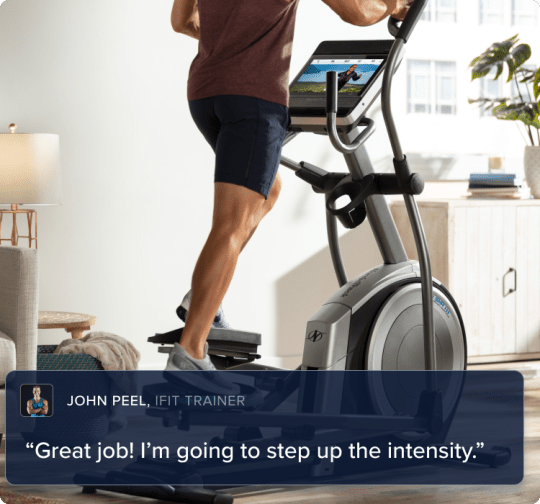 Man engaged in a workout on his 14.9 elliptical, watching his iFIT trainer climb a mountain, all in his own home.