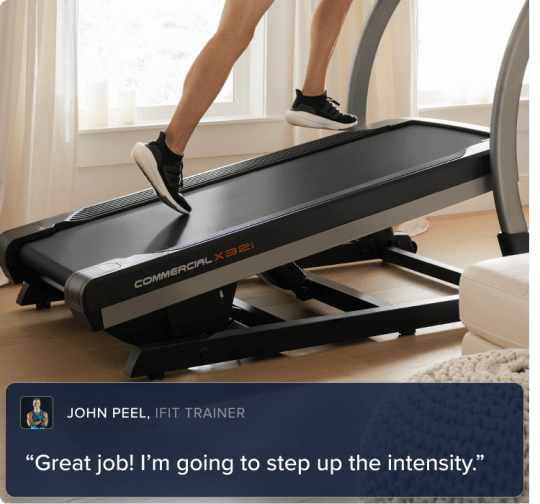 Woman climbing at an incline oh her incline treadmill. The treadmill and the legs on the treadmill belt are shown.