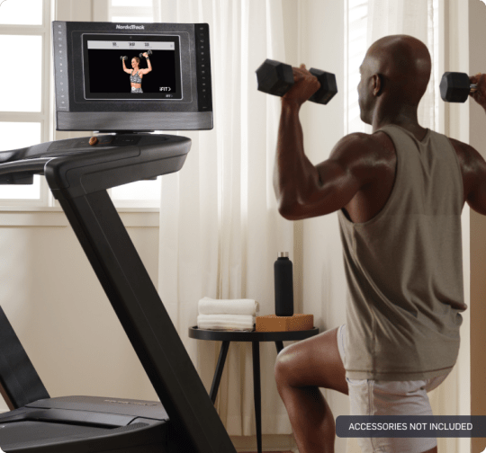 man exercising beside the 1750 treadmill which has its console swiveled to the right