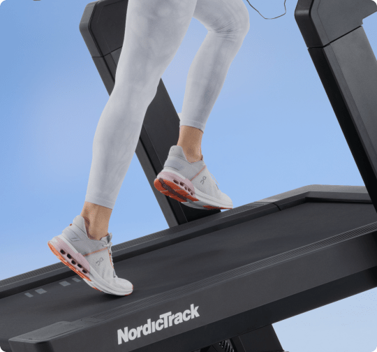 woman using her X24 treadmill at a high incline