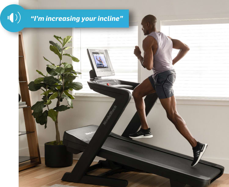 man running on the 1750 treadmill while the ifit trainer controls the workout