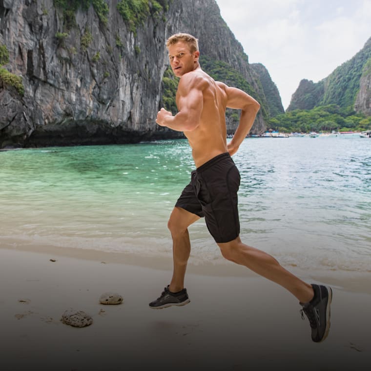 John Peel running on a scenic the beach.