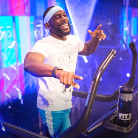 Coach pointing and laughing while jogging on a treadmill
