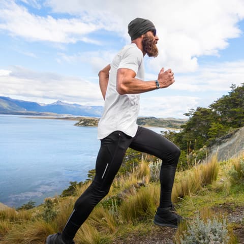 Trainer jogging on a mountain at an incline