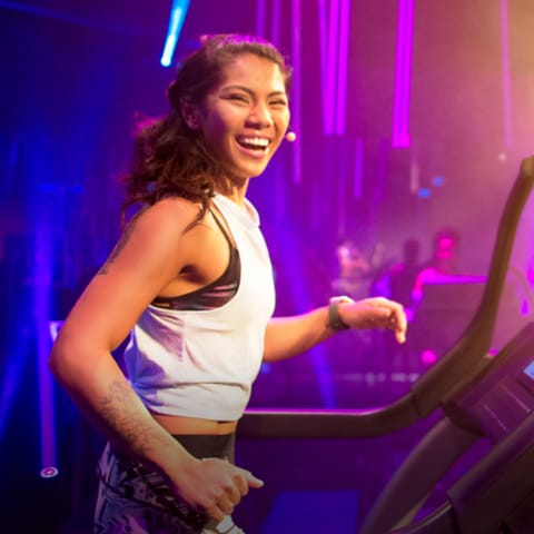 Coach jogging on treadmill, looking at the camera