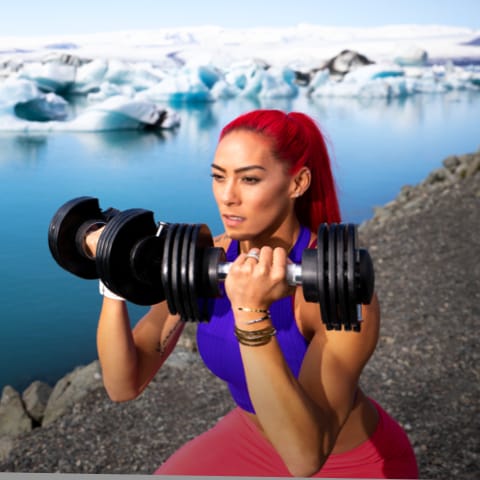 Coach with dumbbells doing a squat-type exercise