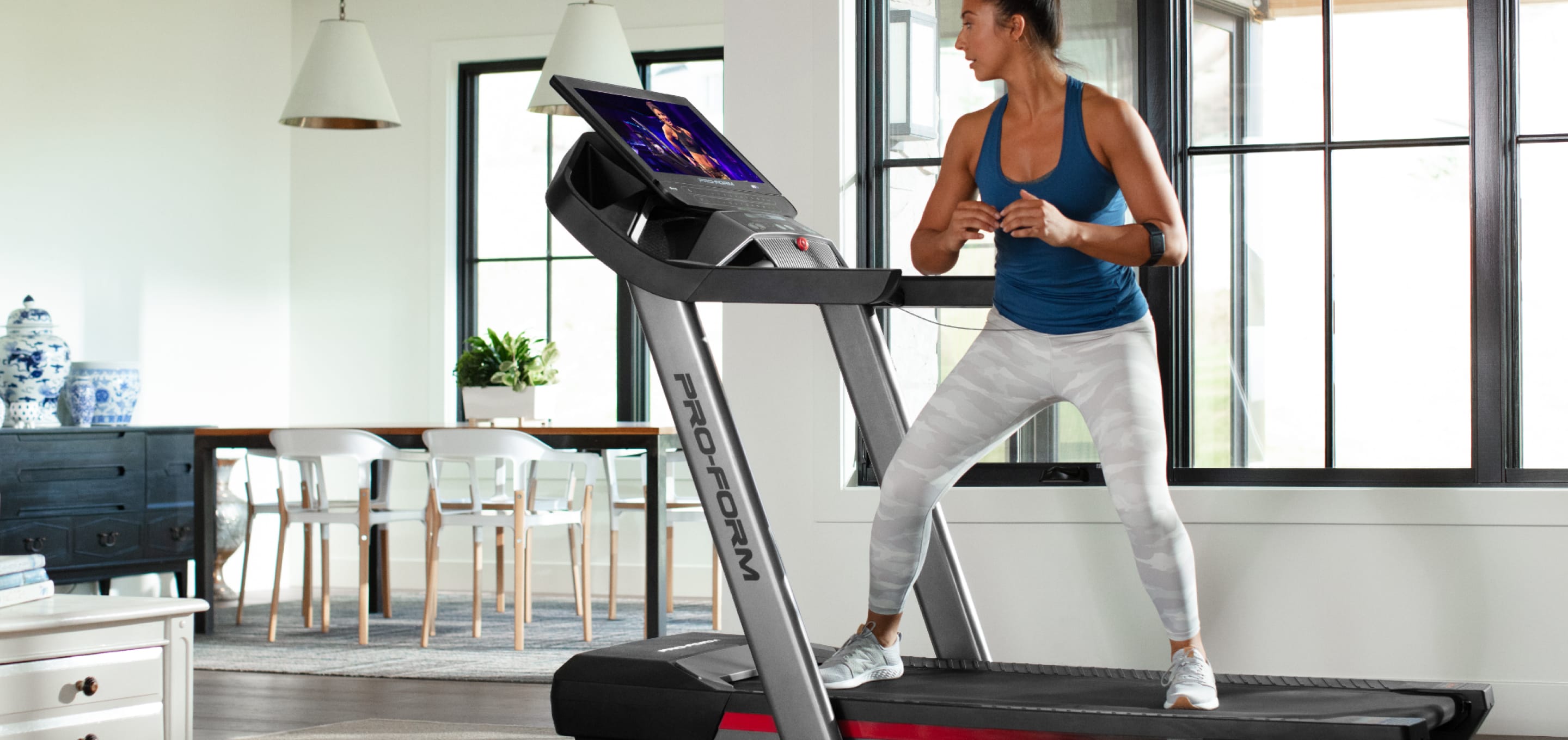 Woman doing a workout on the Pro 9000 treadmill edge.