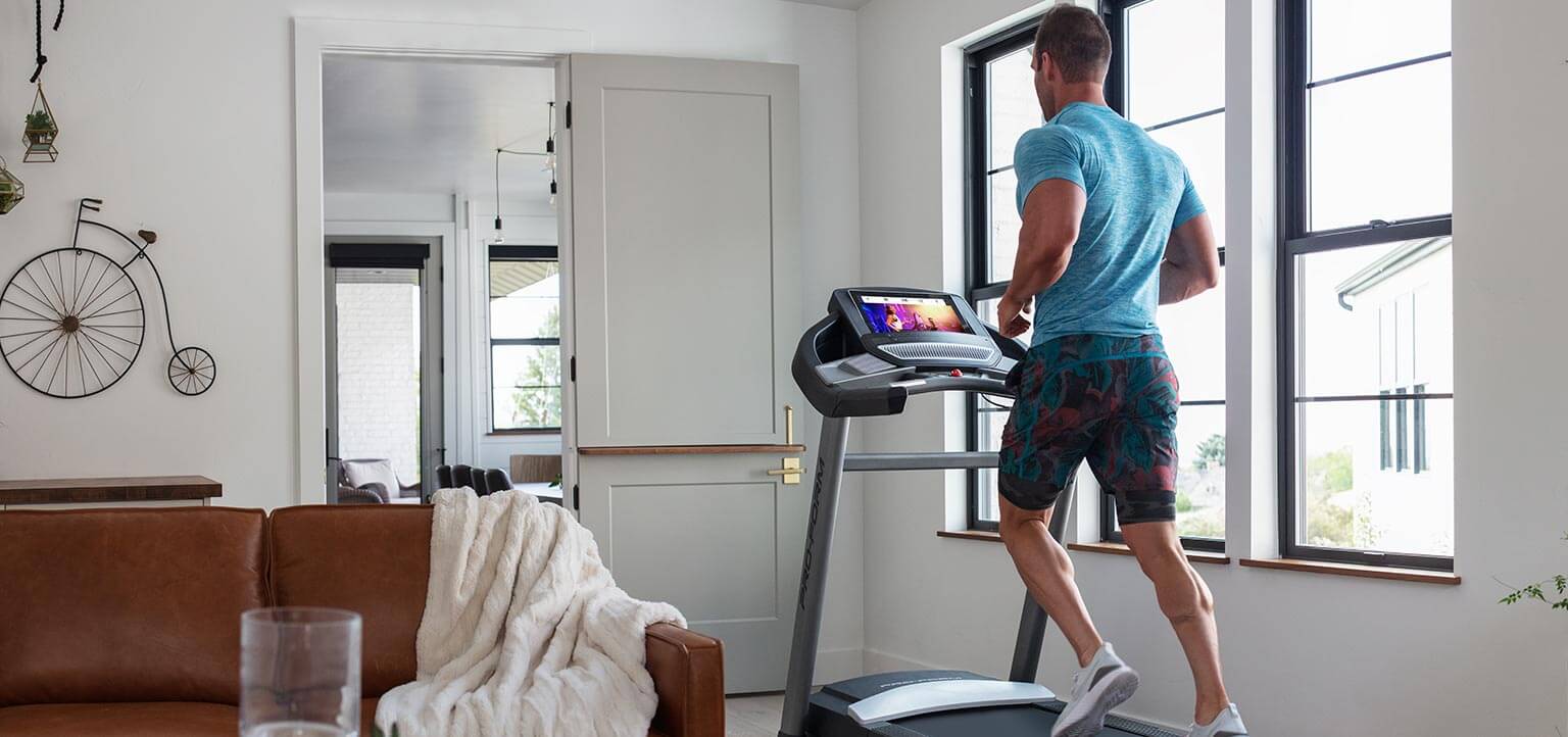 Man running on the SMART Performance 800i inside of his living room.