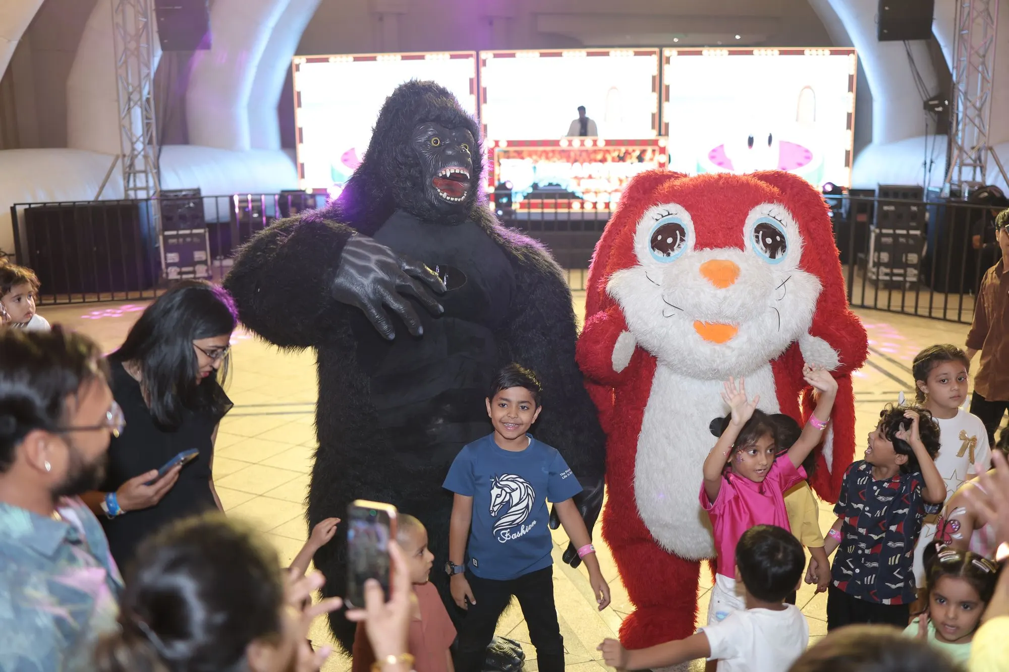 Children meeting costumed mascots at Toddler Techno Party