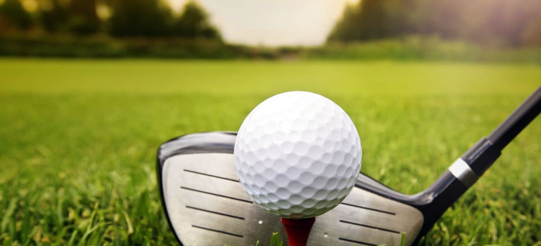Golf Driver behind a white golf ball