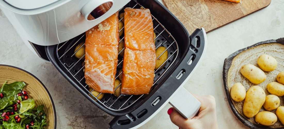 White Air Fryer Cooking some Salmon first then potatoes