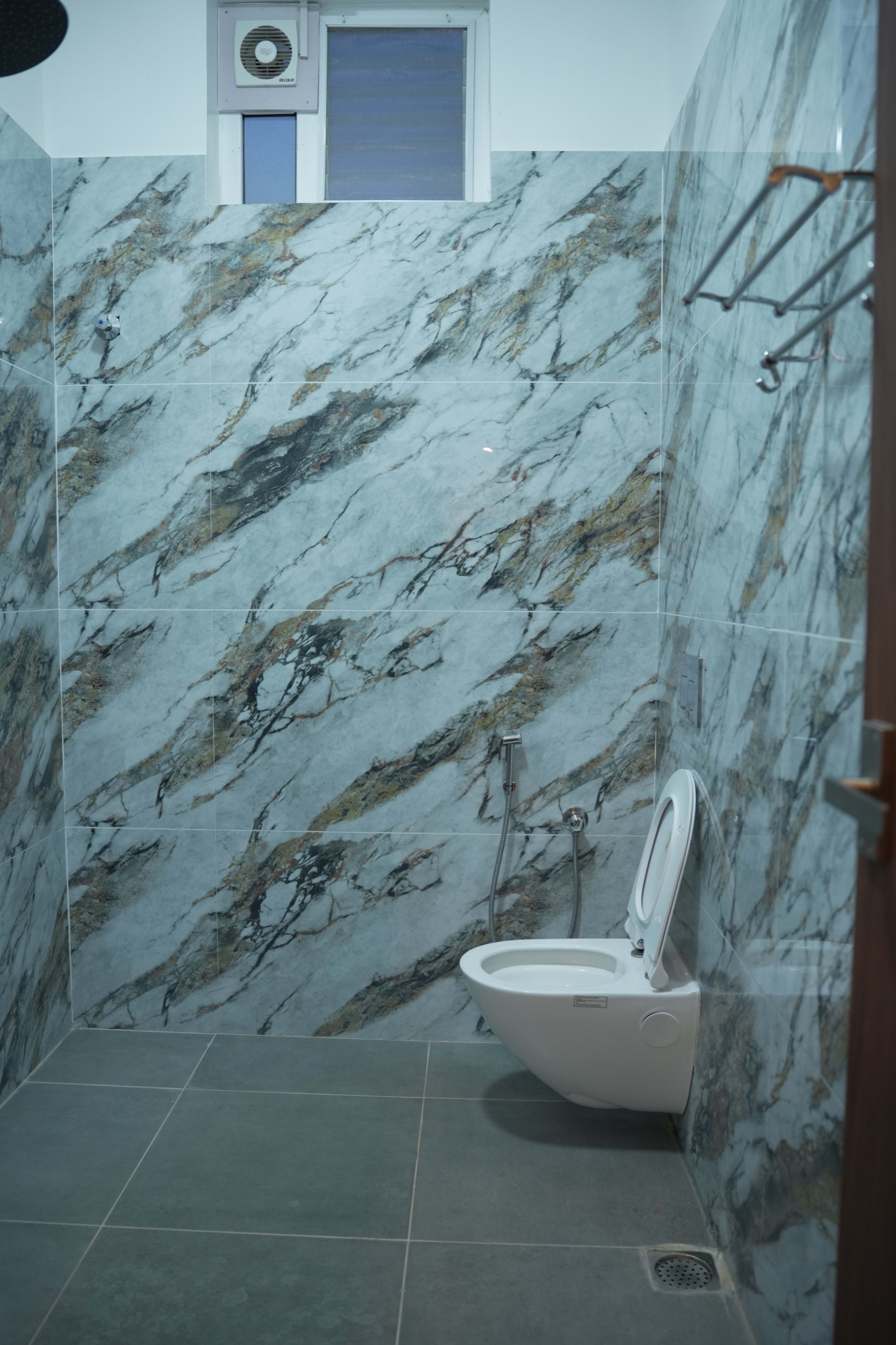Clean modern bathroom in the Premium Comfort Room — UJ Pallazzio, Tiruvannamalai